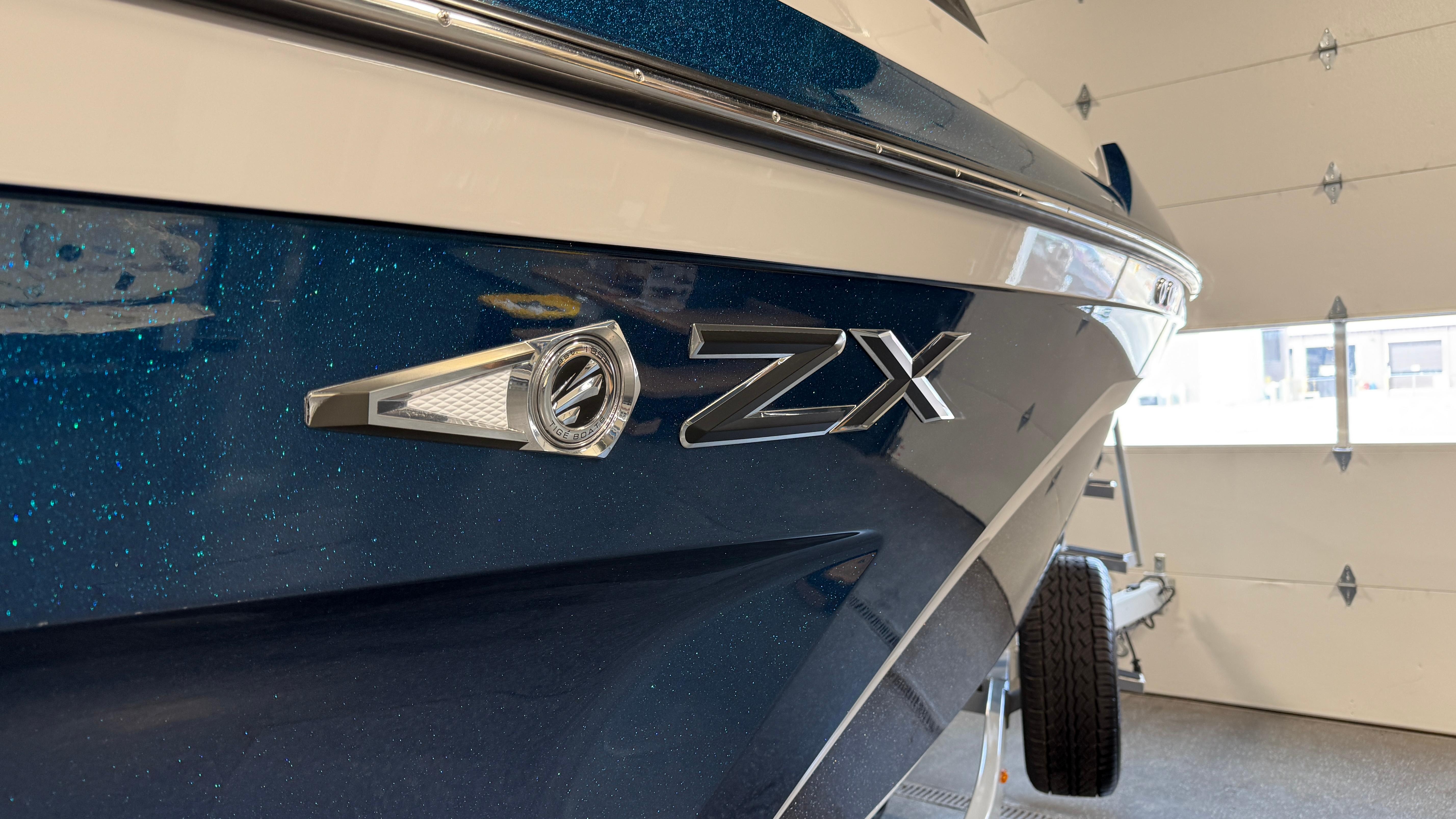2022 Tigé 23ZX boat in a garage, showcasing sleek blue exterior design.