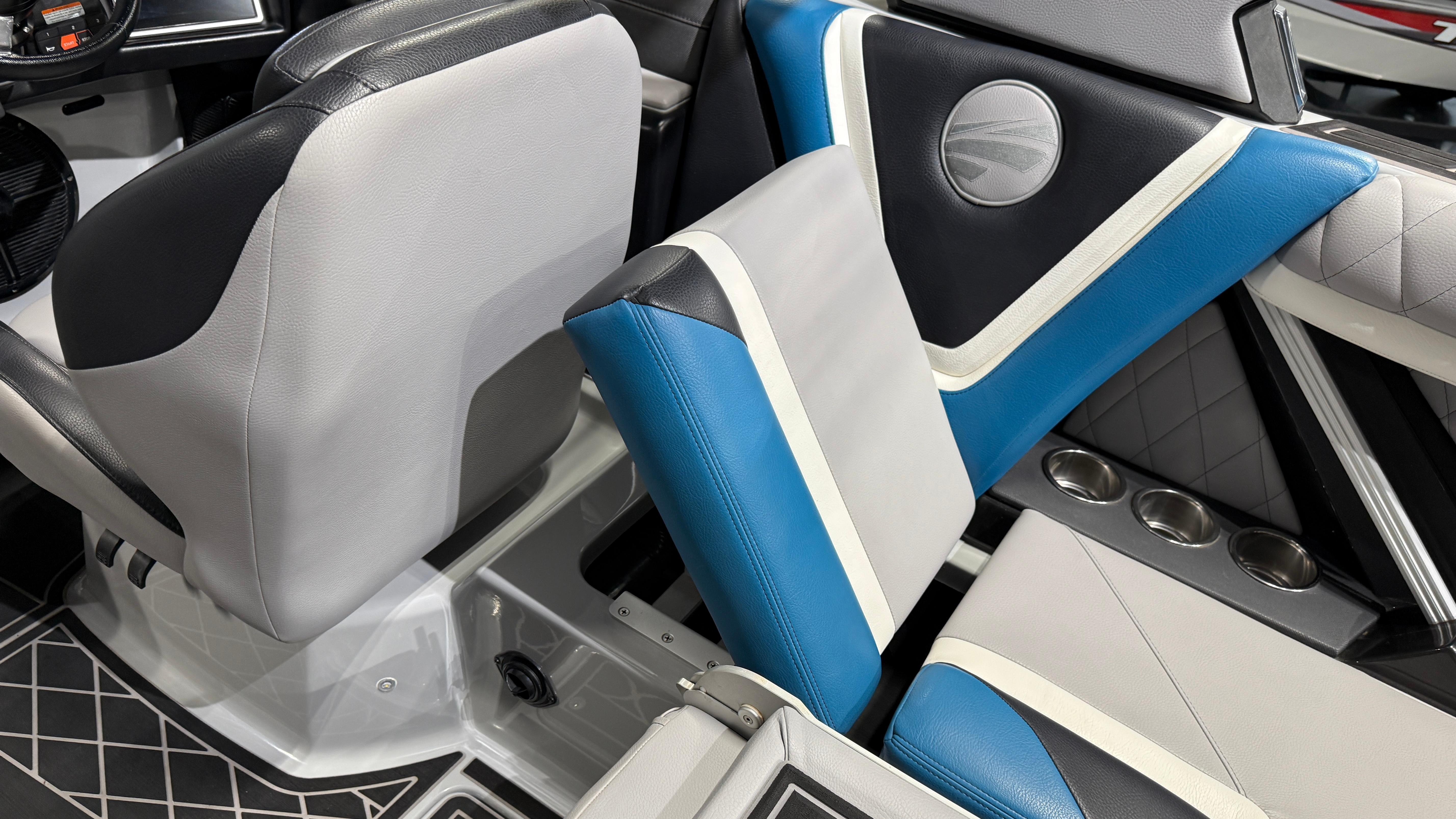 2022 Tigé 23ZX boat interior with blue and gray seating and cup holders.