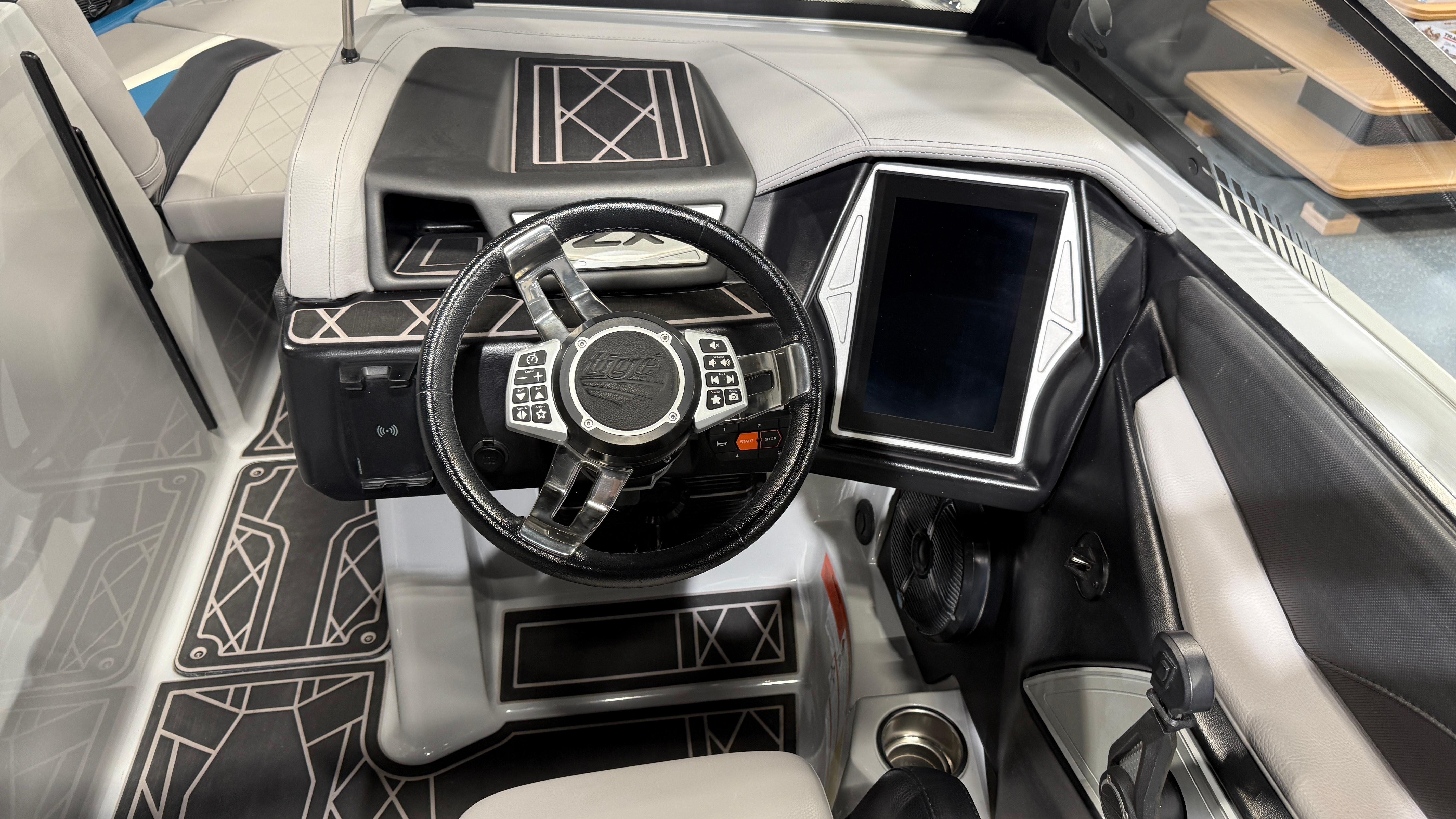 2022 Tigé 23ZX boat dashboard with modern steering wheel and touchscreen display.