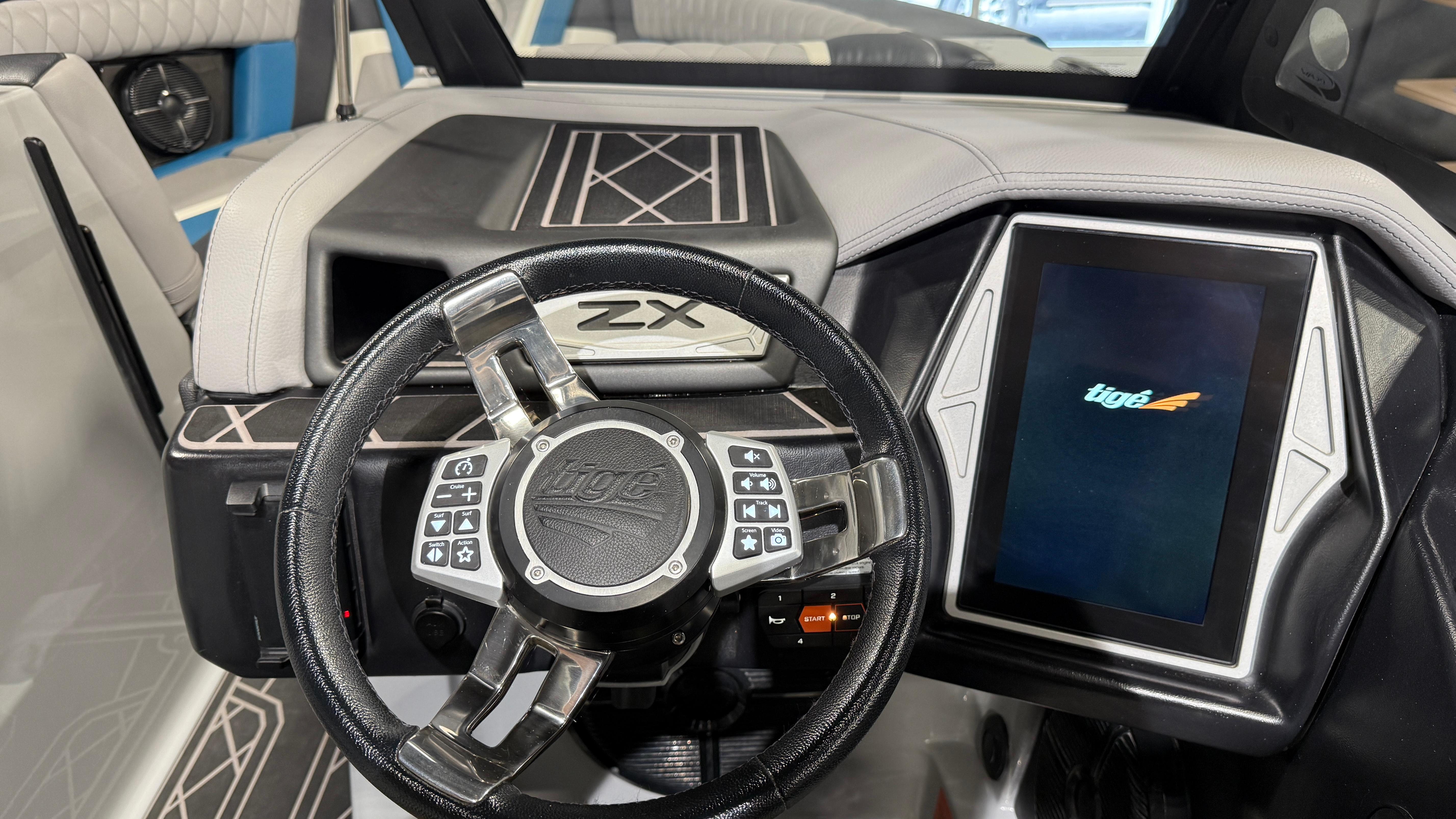 2022 Tigé 23ZX boat dashboard with touchscreen and steering wheel.