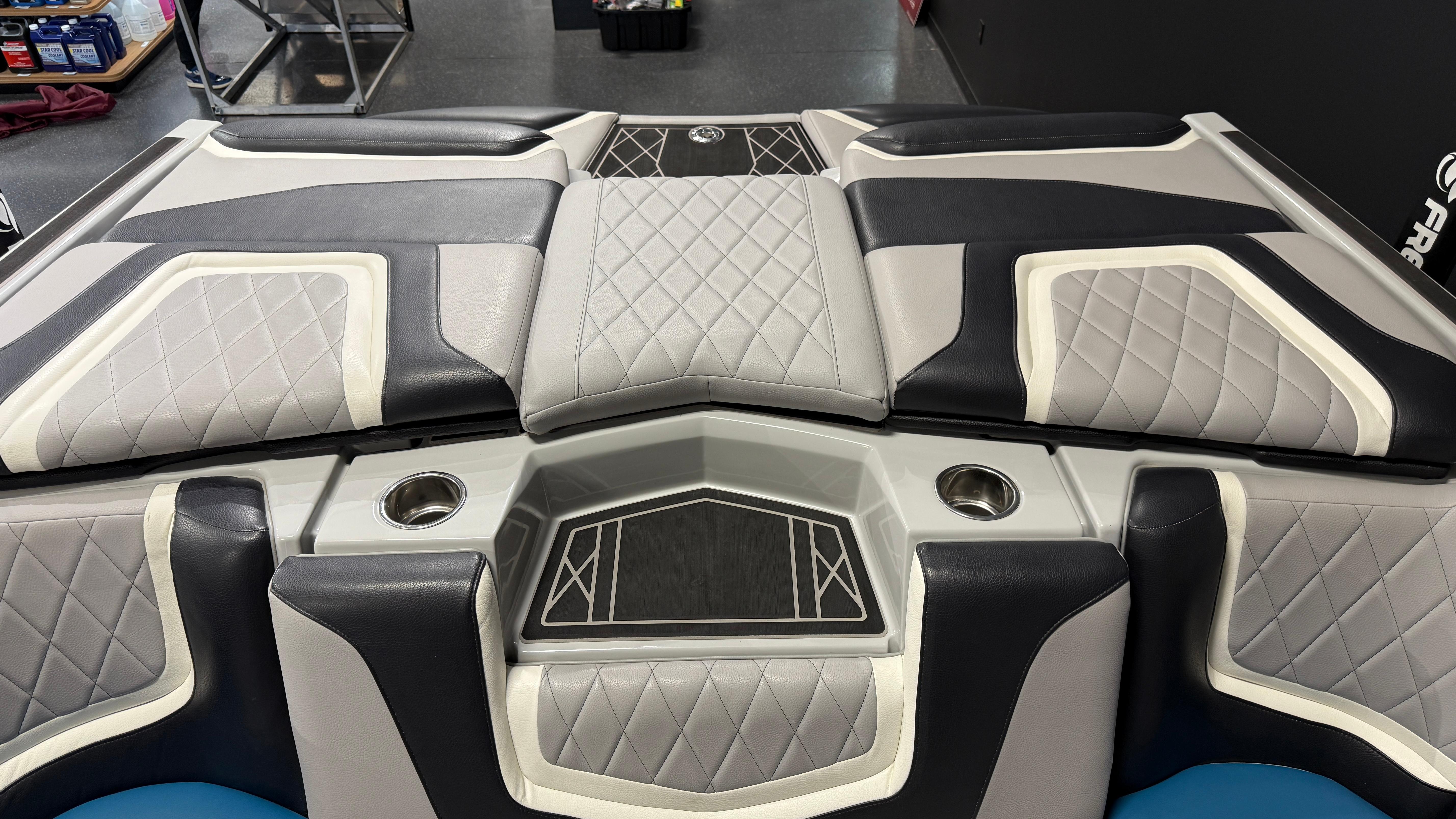 2022 Tigé 23ZX boat interior with diamond-stitched upholstery and cup holders.