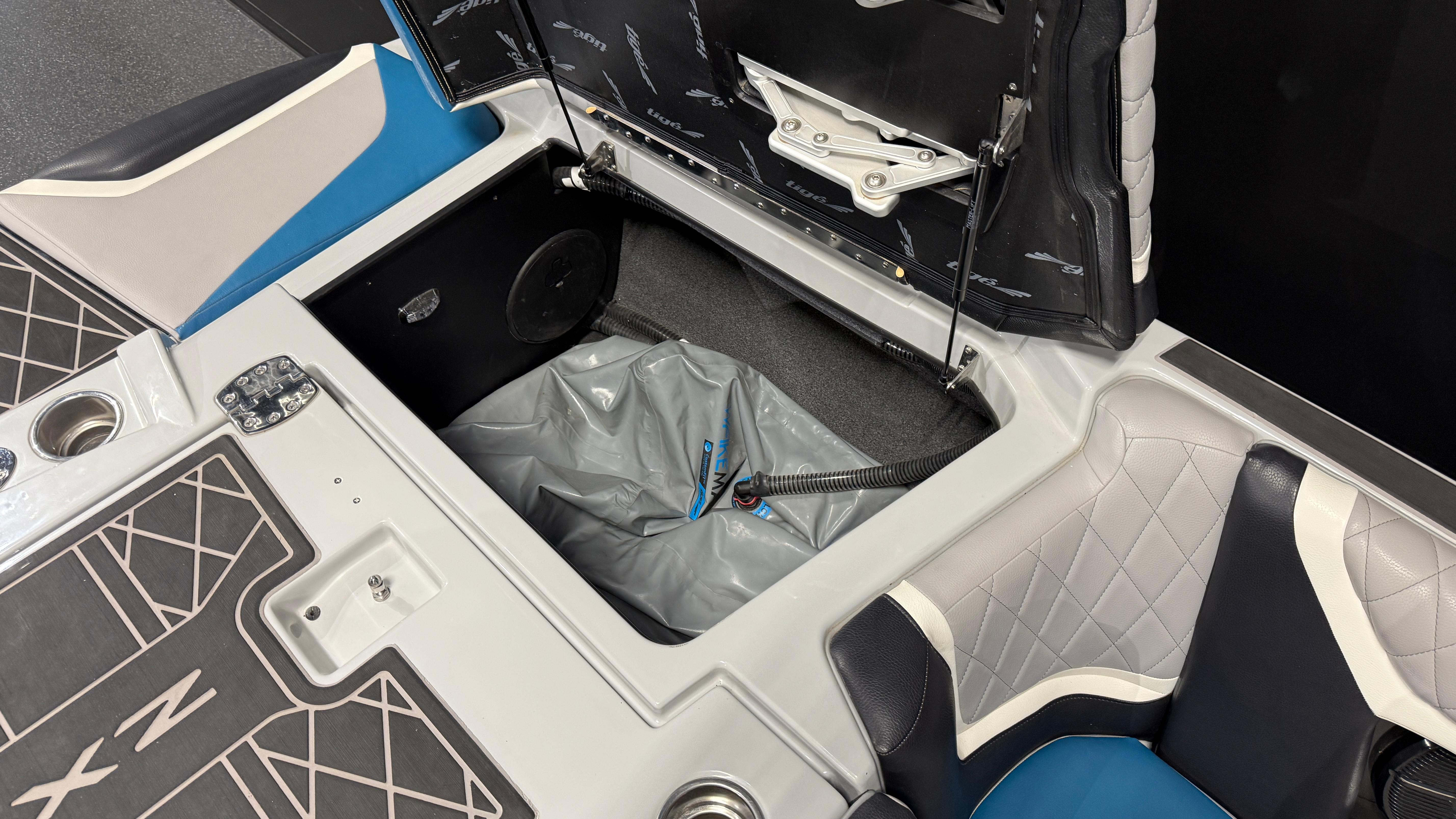 2022 Tigé 23ZX boat interior storage compartment with blue and gray seating.