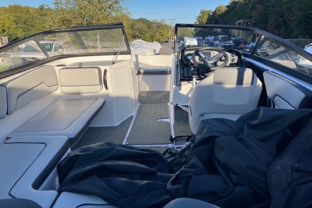 2023 Yamaha Boats AR190 interior with seating and steering wheel, parked outdoors.