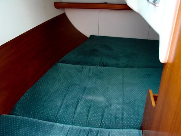 Interior of a 2001 Beneteau 331 yacht with green upholstery.