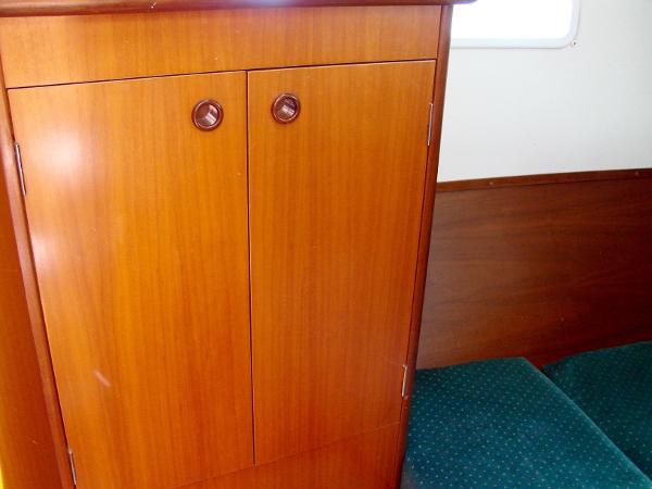 Interior of 2001 Beneteau 331 featuring wooden cabinet.