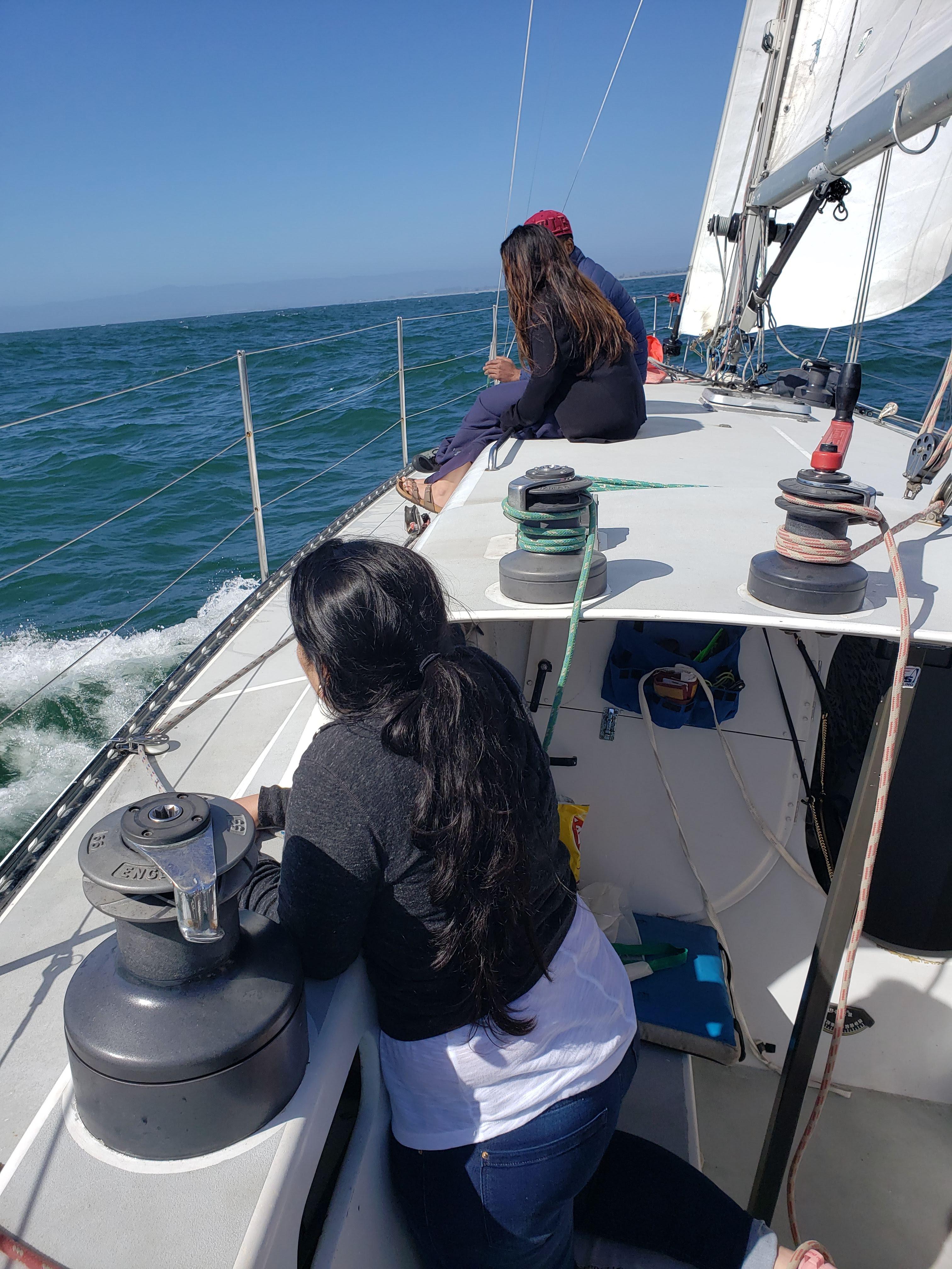 People sailing on a 1986 Santa Cruz 50 yacht in open waters.