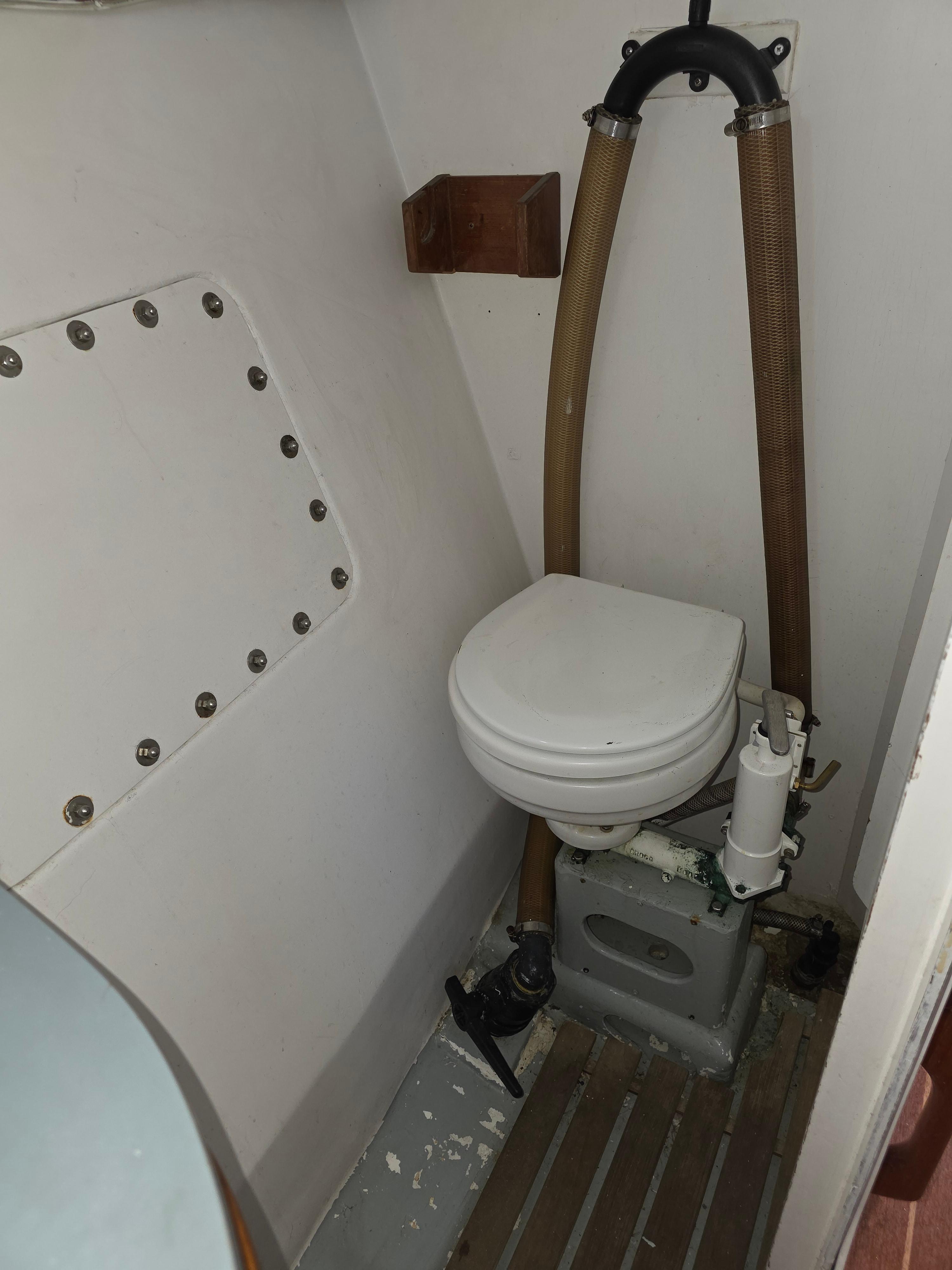 Compact marine toilet in 1986 Santa Cruz 50 sailboat bathroom.