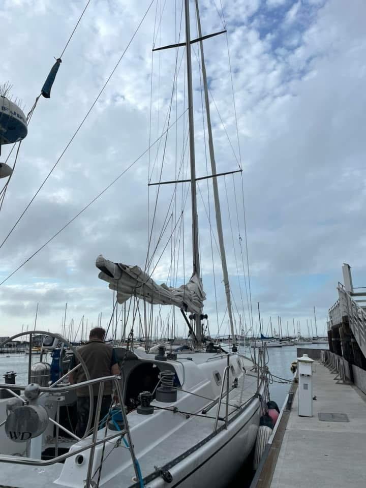 1986 Santa Cruz 50 sailboat docked at marina under cloudy sky.
