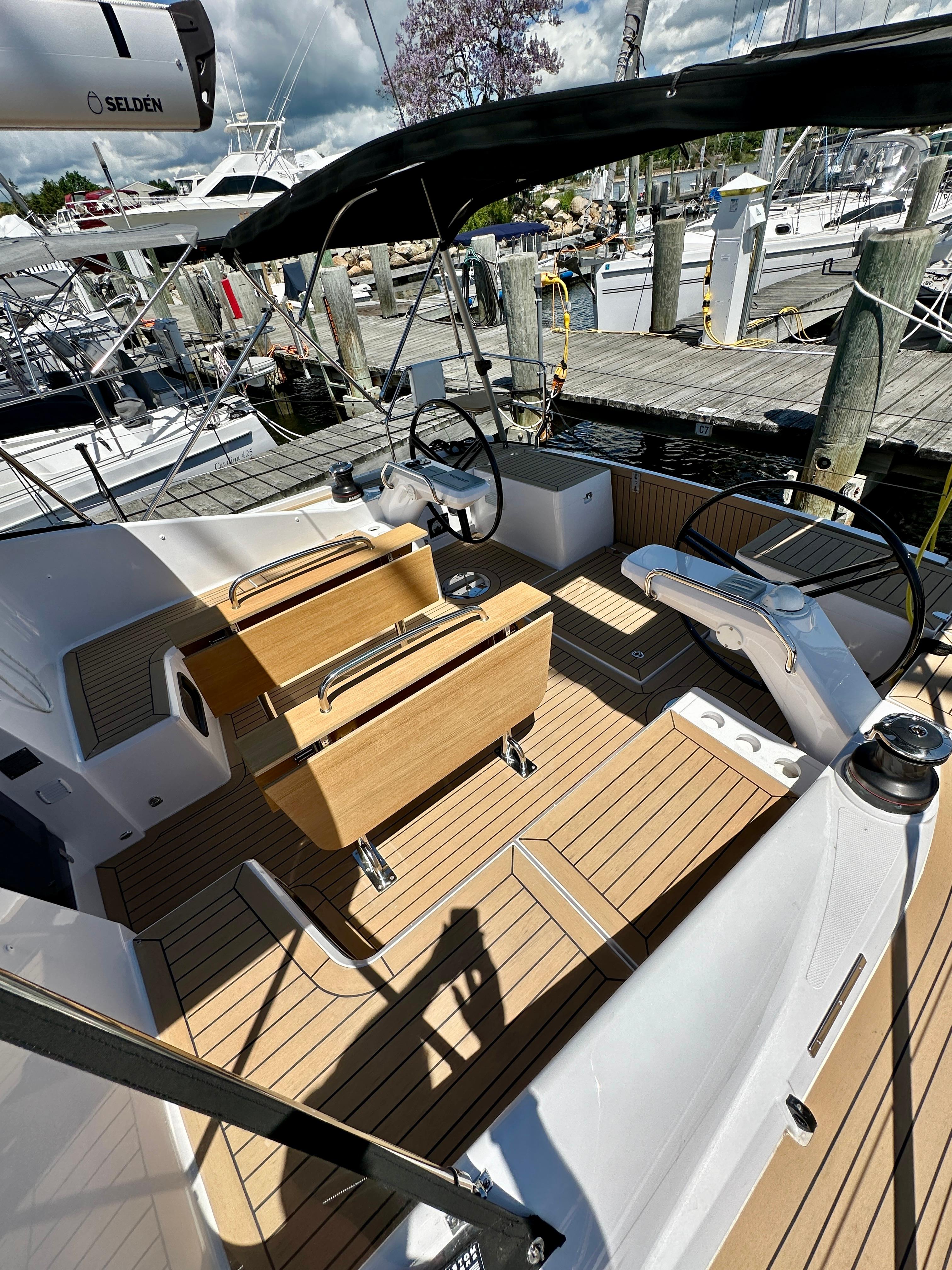 Elan-Impression 43 2024-Hard Loaded CT-US-2024 Elan Impression 43 yacht cockpit with wooden deck and dual steering wheels.-9178291 | Thumbnail
