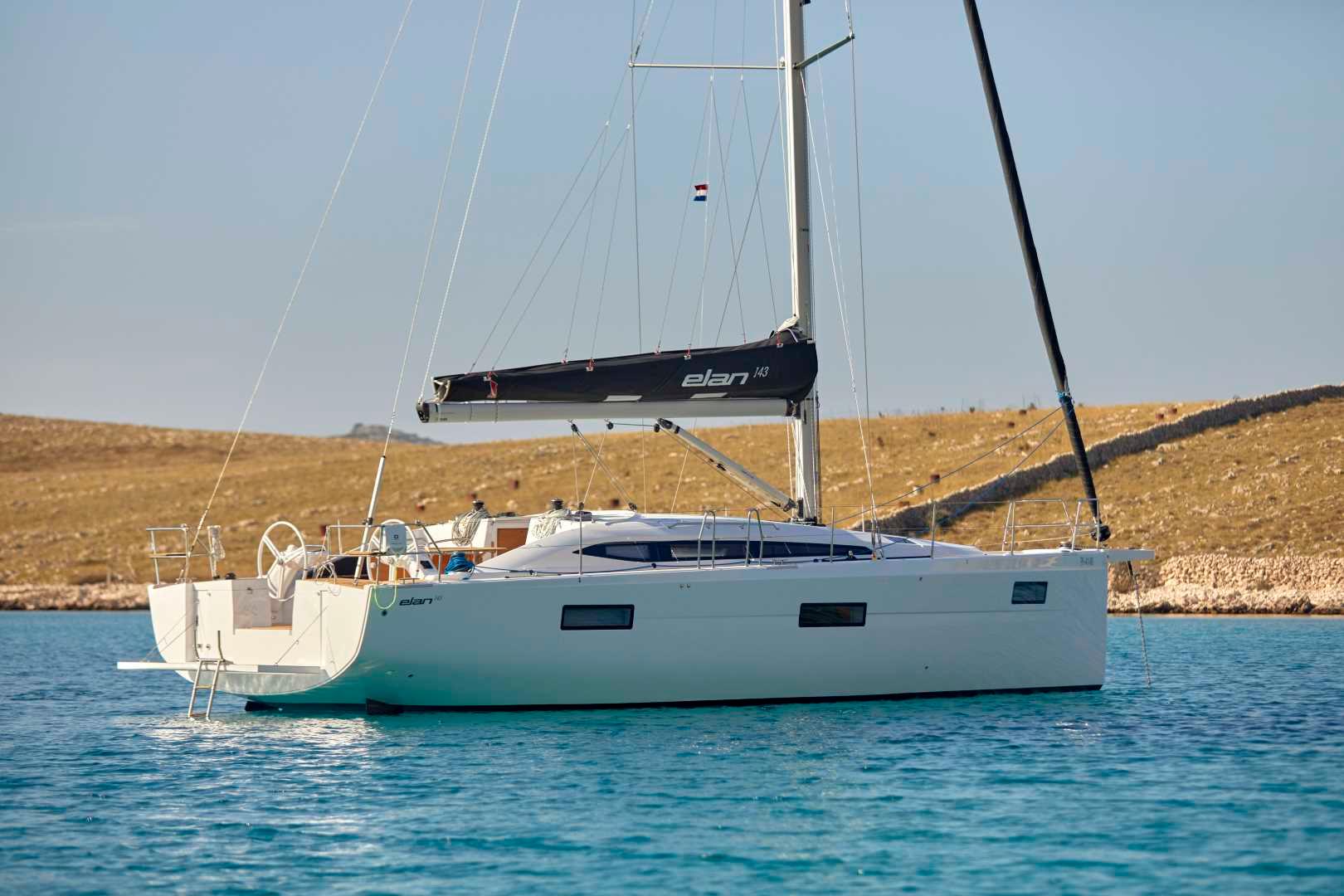 Elan-Impression 43 2024-Hard Loaded CT-US-2024 Elan Impression 43 sailboat anchored in clear blue water.-9178291 | Thumbnail