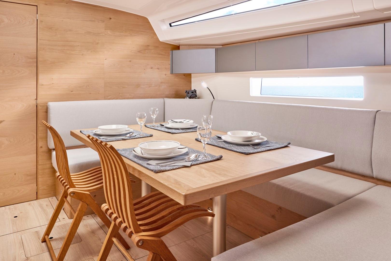 Elan-Impression 43 2024-Hard Loaded CT-US-Modern dining area inside 2024 Elan Impression 43 yacht with wooden table and chairs.-9178291 | Thumbnail