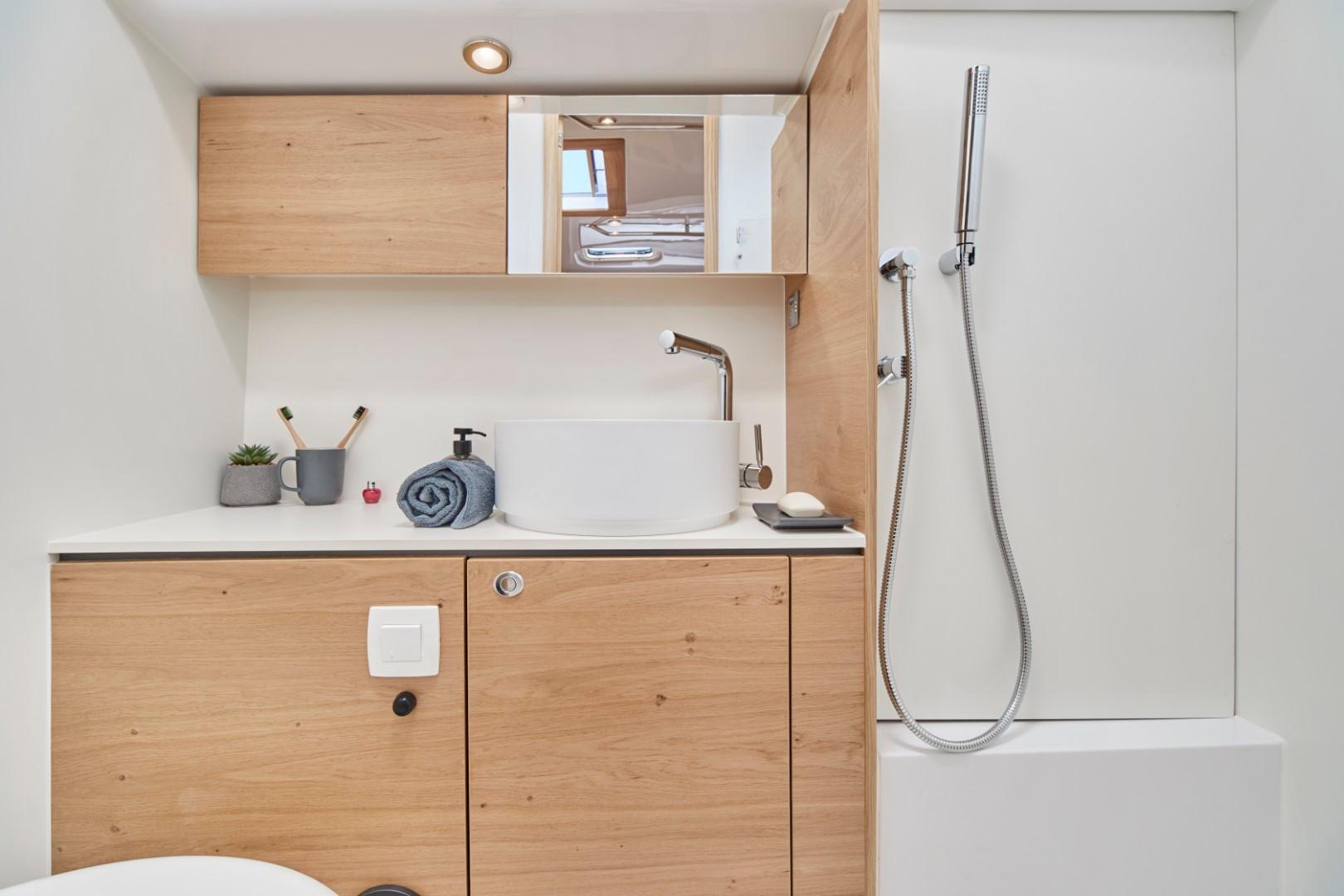 Elan-Impression 43 2024-Hard Loaded CT-US-Modern bathroom in 2024 Elan Impression 43 yacht with wooden cabinets and sleek fixtures.-9178291 | Thumbnail