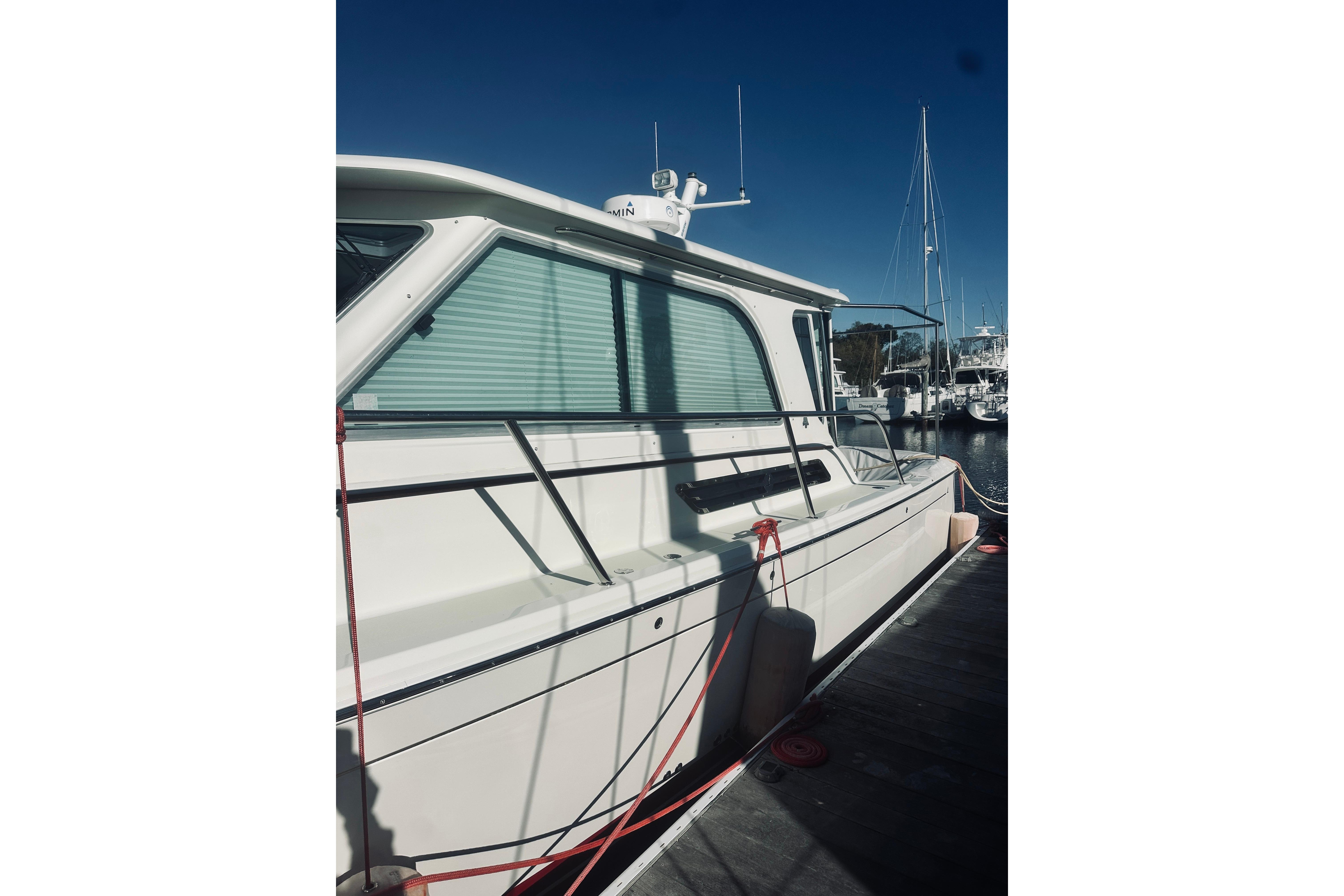 2021 Back Cove 37 boat docked at marina under clear blue sky.