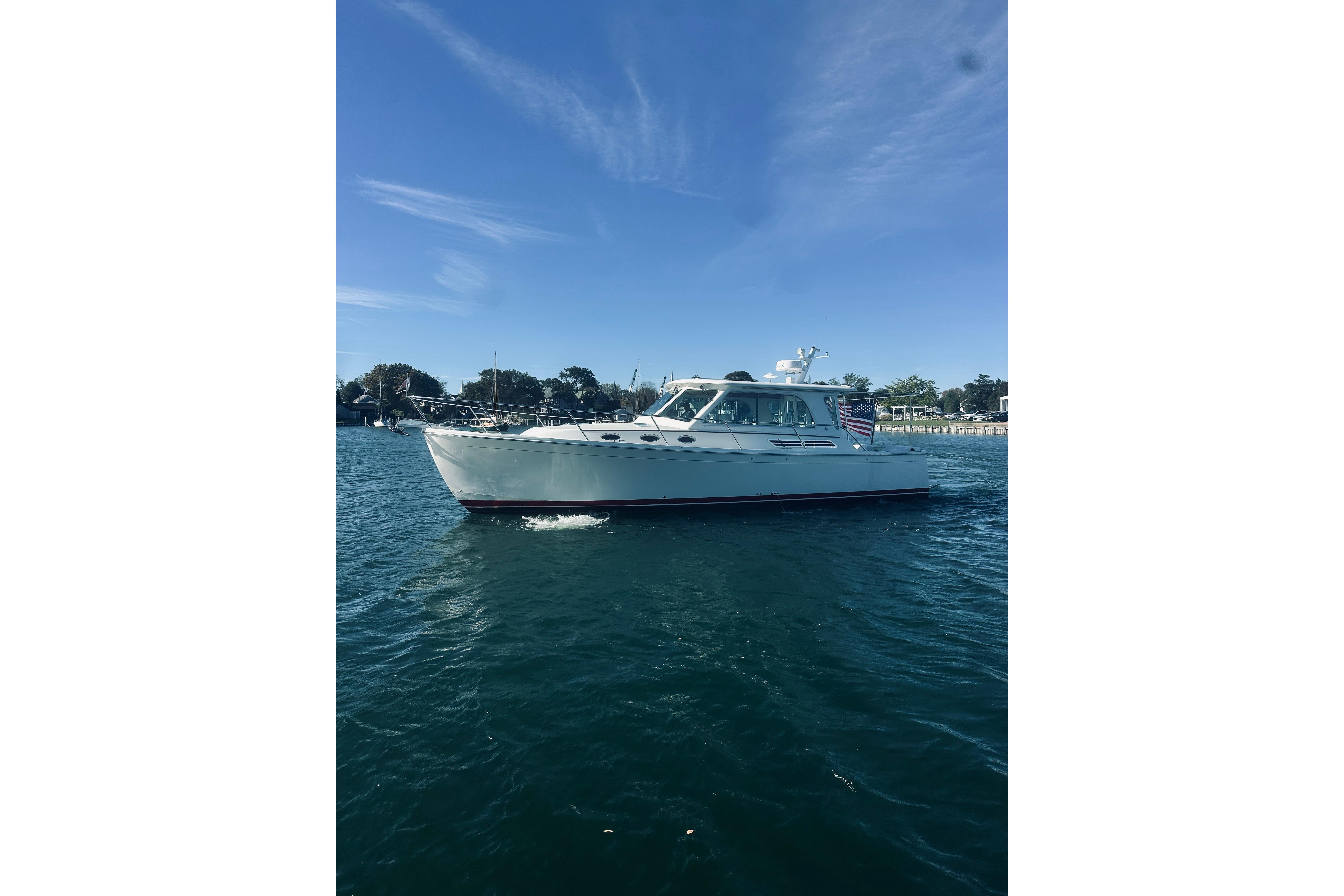 2021 Back Cove 37 boat cruising on a sunny day, with clear blue skies.