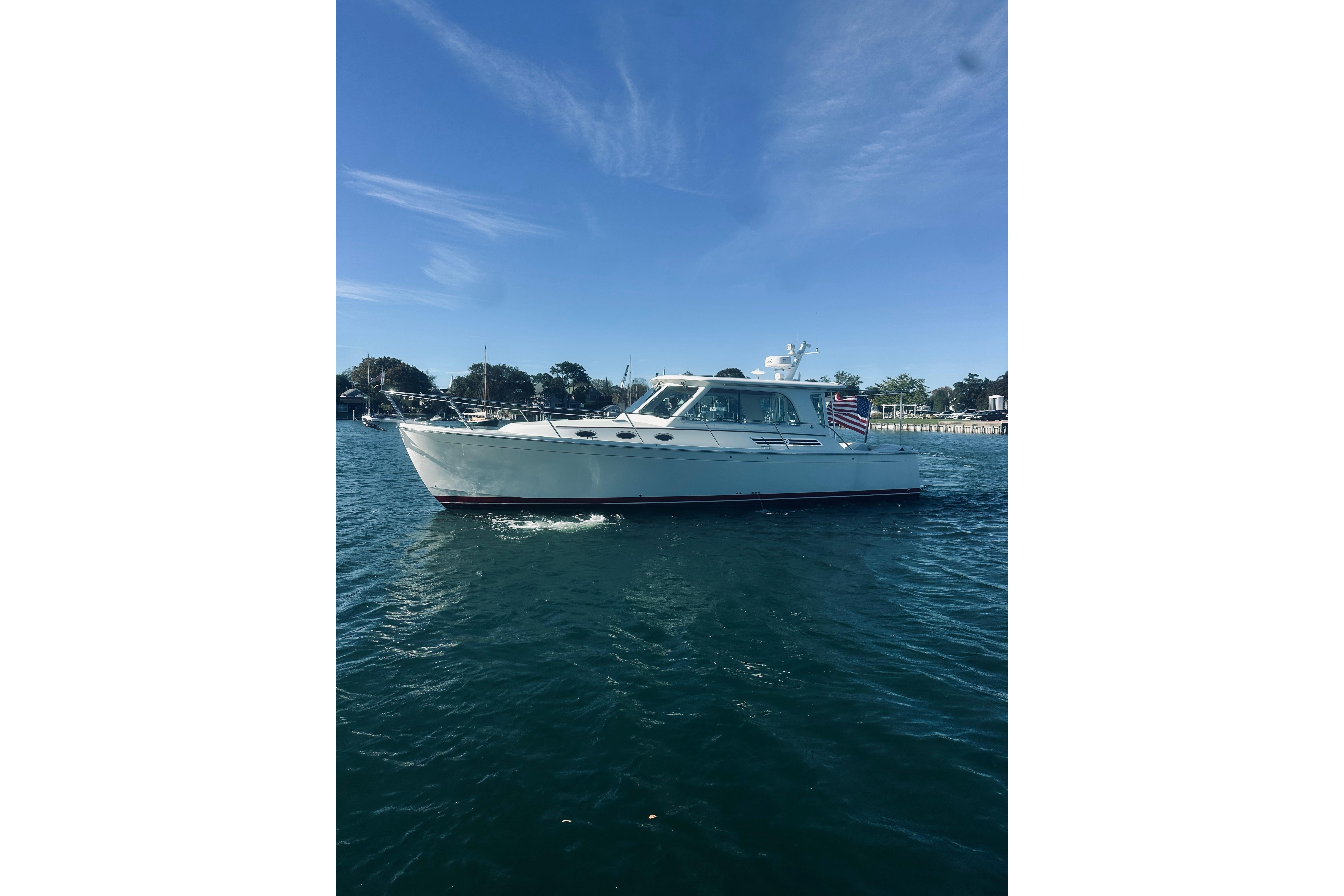 2021 Back Cove 37 boat cruising on calm waters under a clear blue sky.