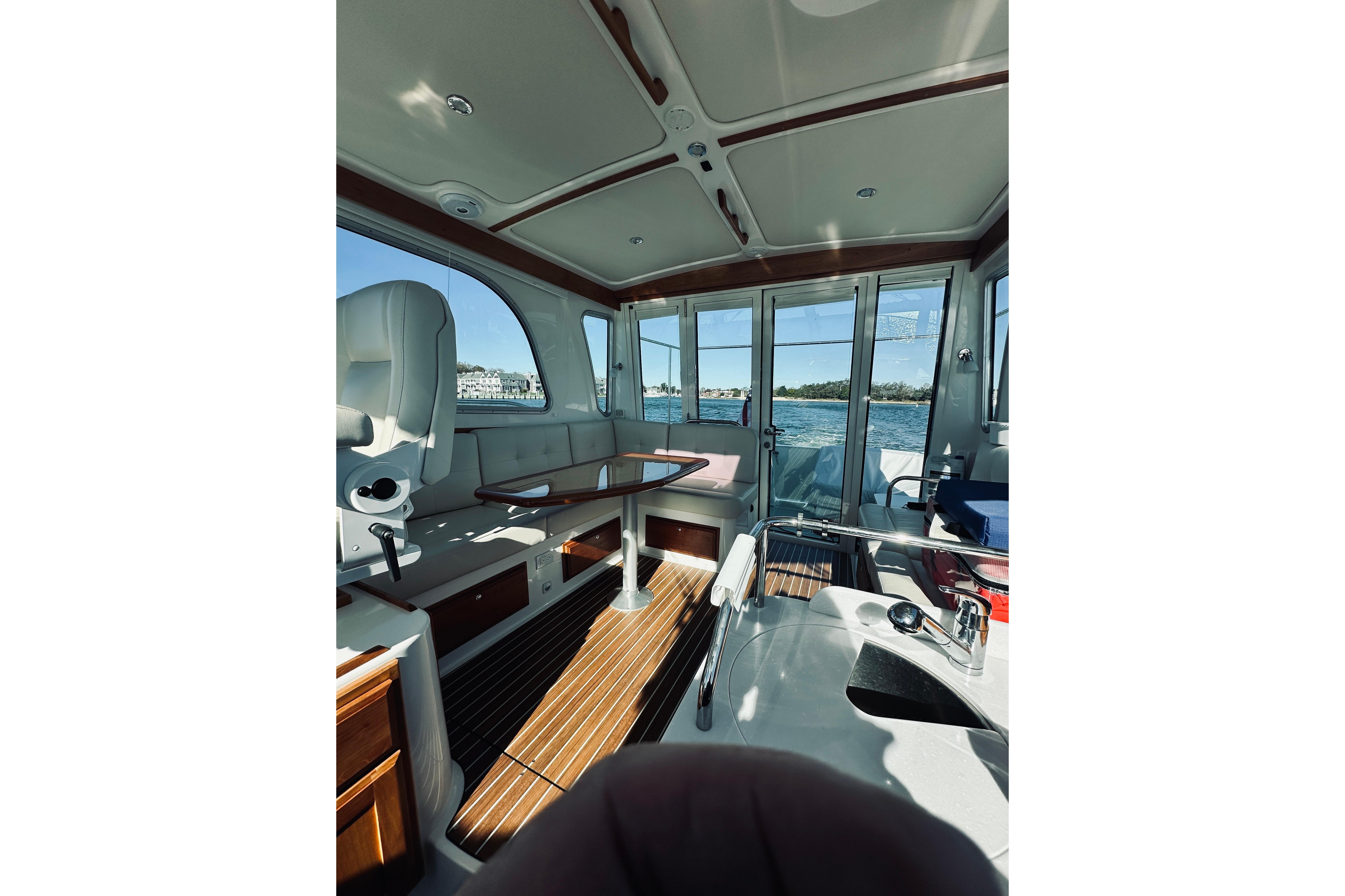Interior of 2021 Back Cove 37 boat with seating and ocean view.