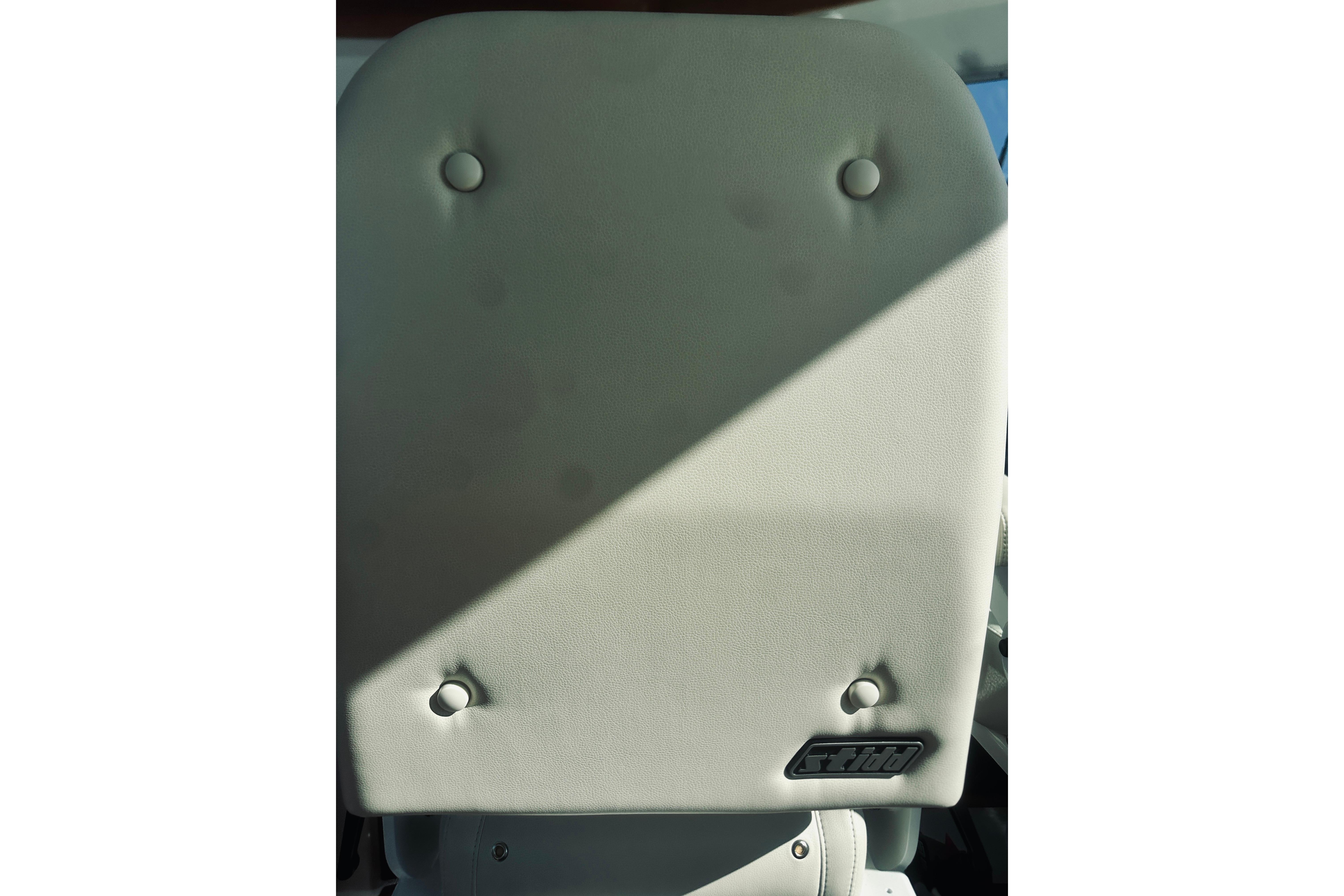 Back Cove 37 (2021) boat seat with light gray upholstery and button details.