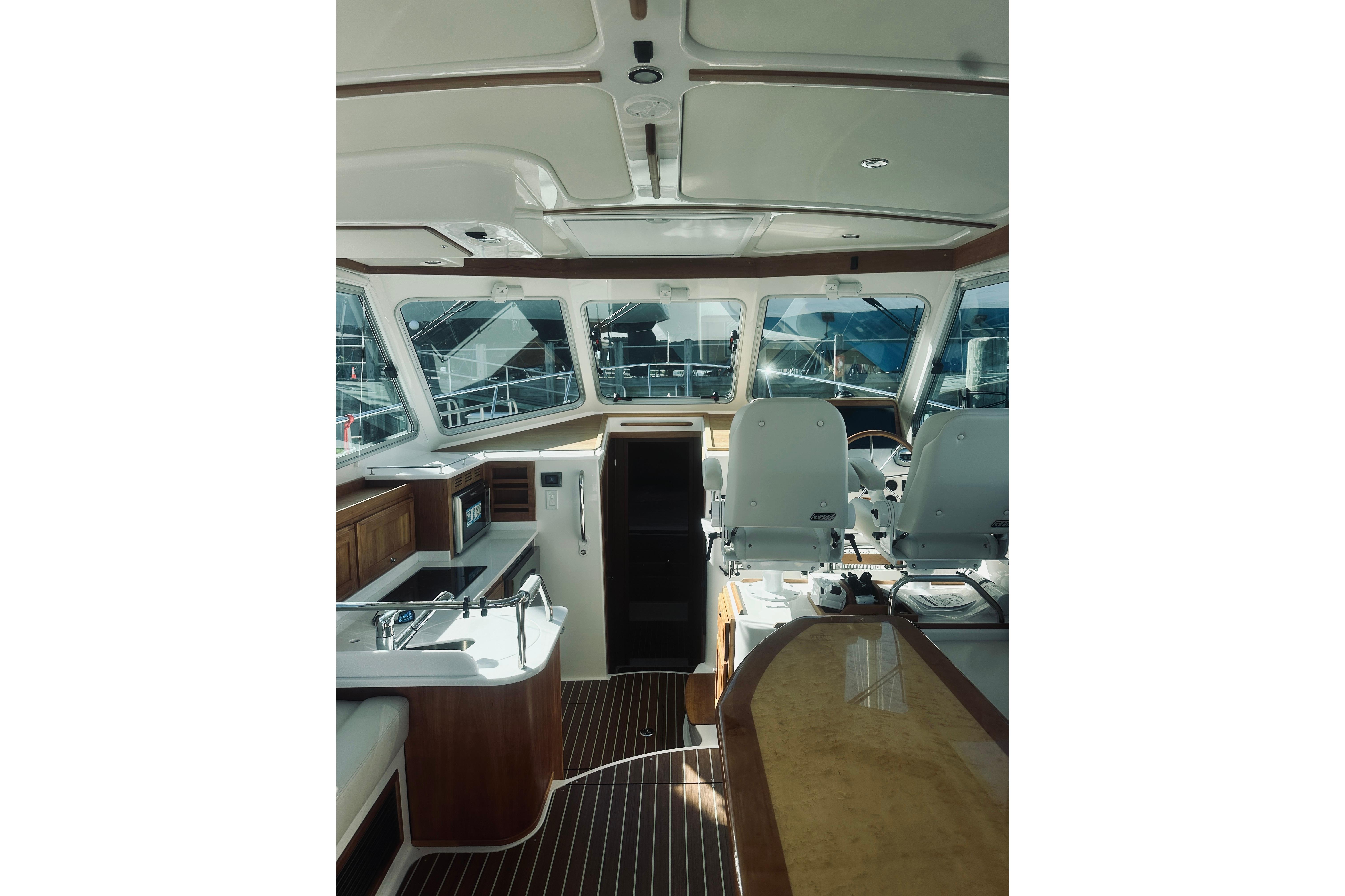Interior of 2021 Back Cove 37 yacht, featuring helm and galley area with modern amenities.