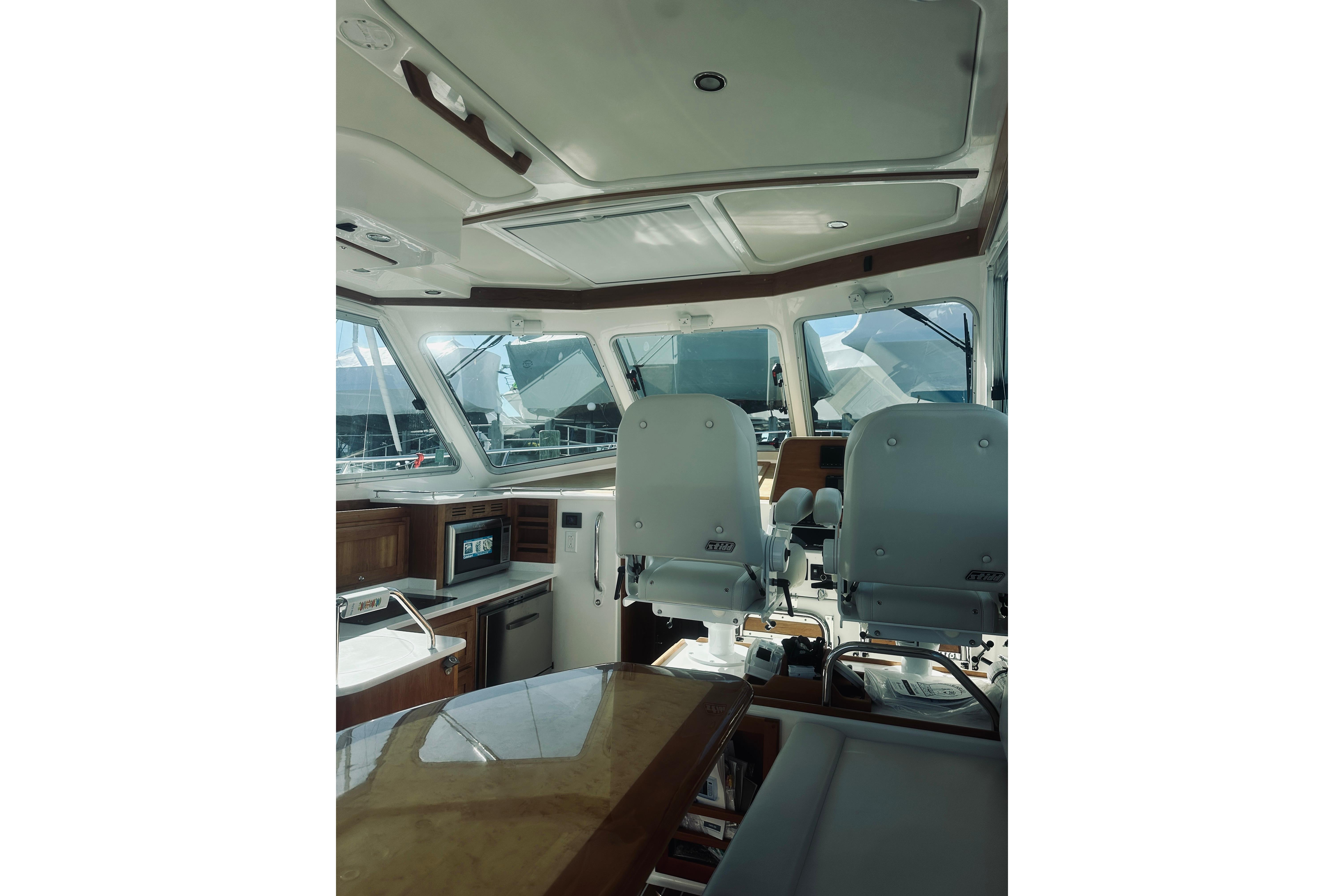 Interior of 2021 Back Cove 37 yacht, featuring helm seats and navigation area.