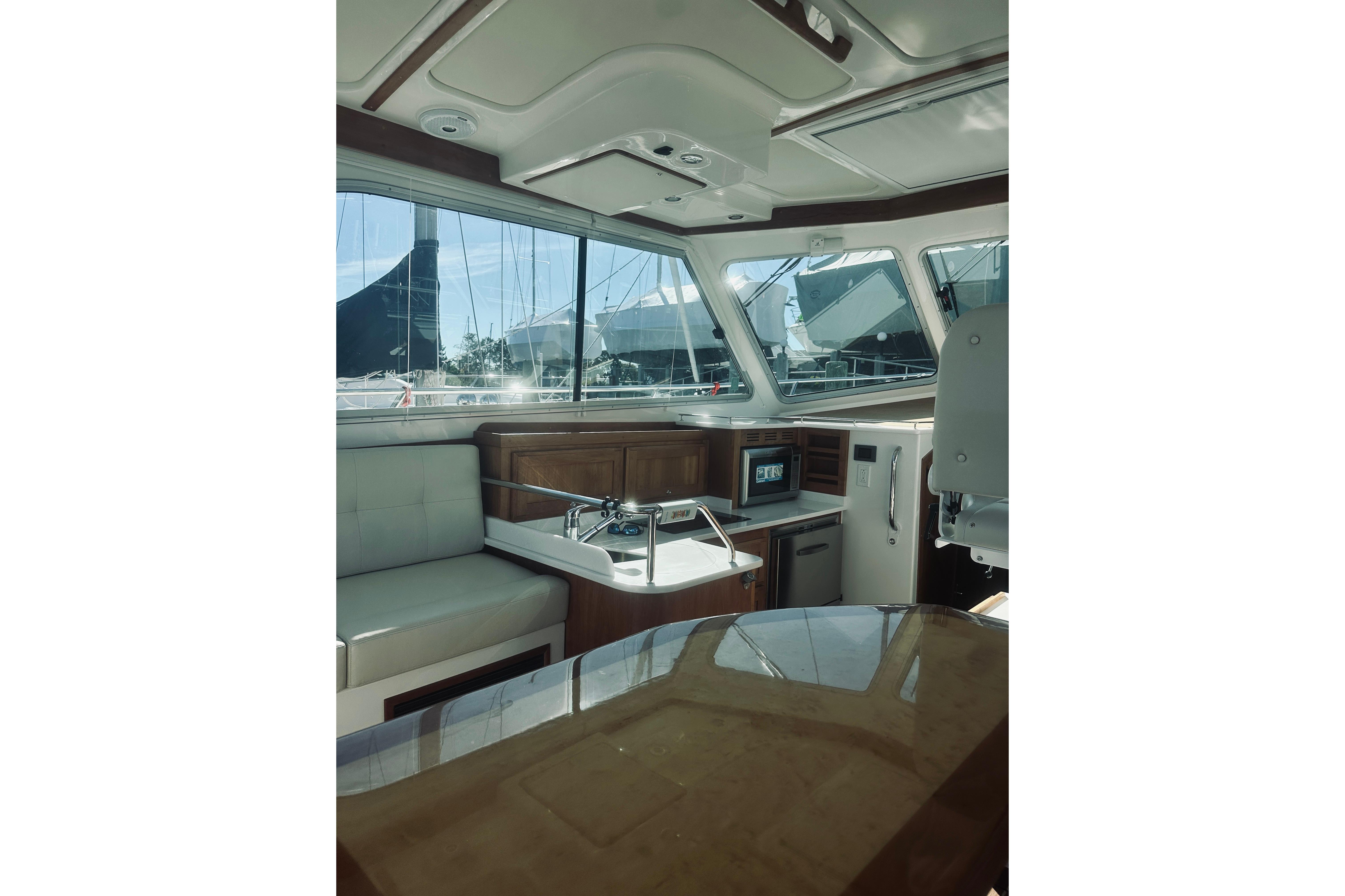 Interior of 2021 Back Cove 37 yacht, featuring modern seating and navigation area.