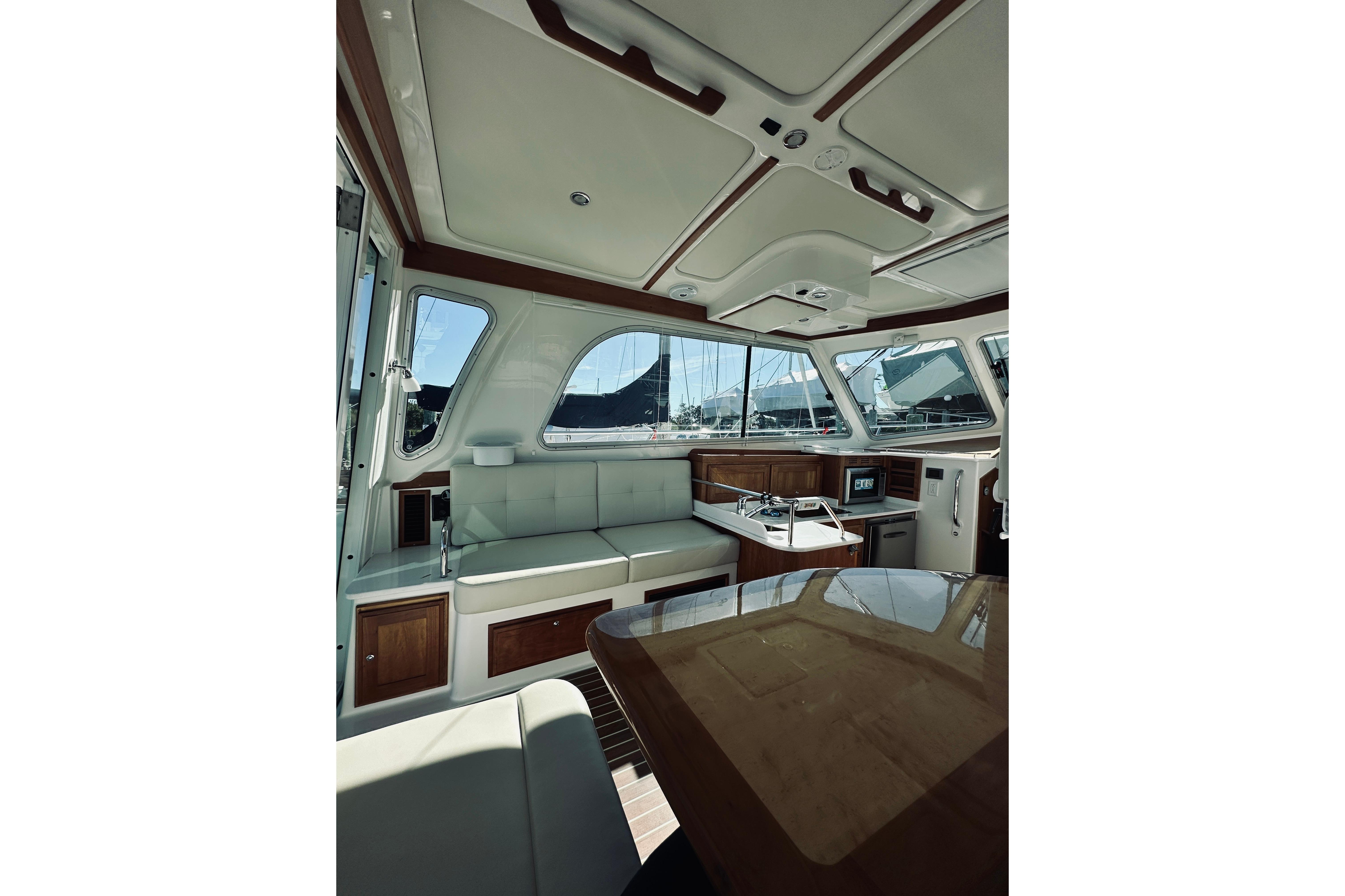 Interior of 2021 Back Cove 37 yacht, featuring elegant seating and modern amenities.