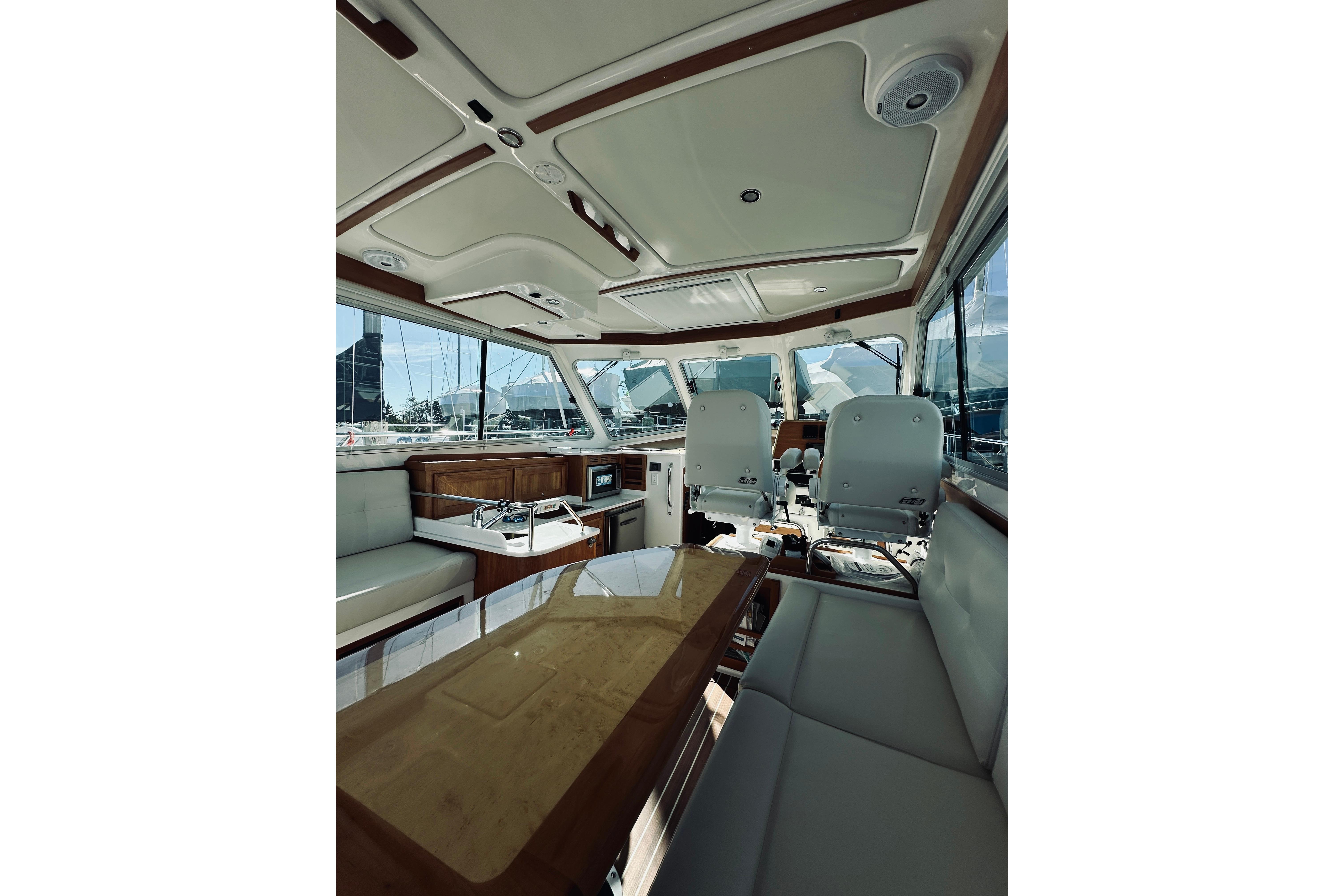 Interior of 2021 Back Cove 37 yacht, featuring seating and helm area.