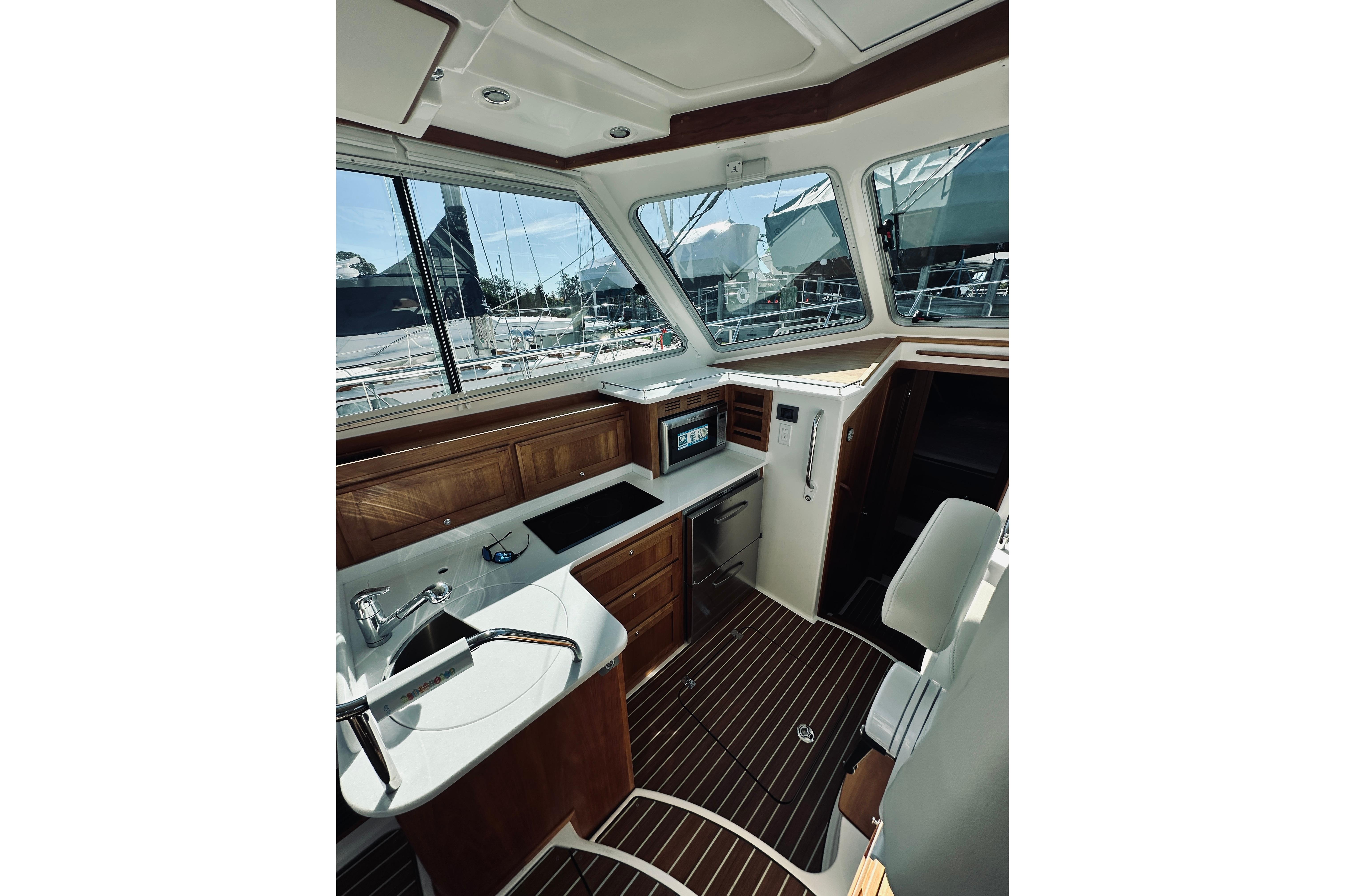 Interior of 2021 Back Cove 37 yacht with modern kitchen and wooden accents.