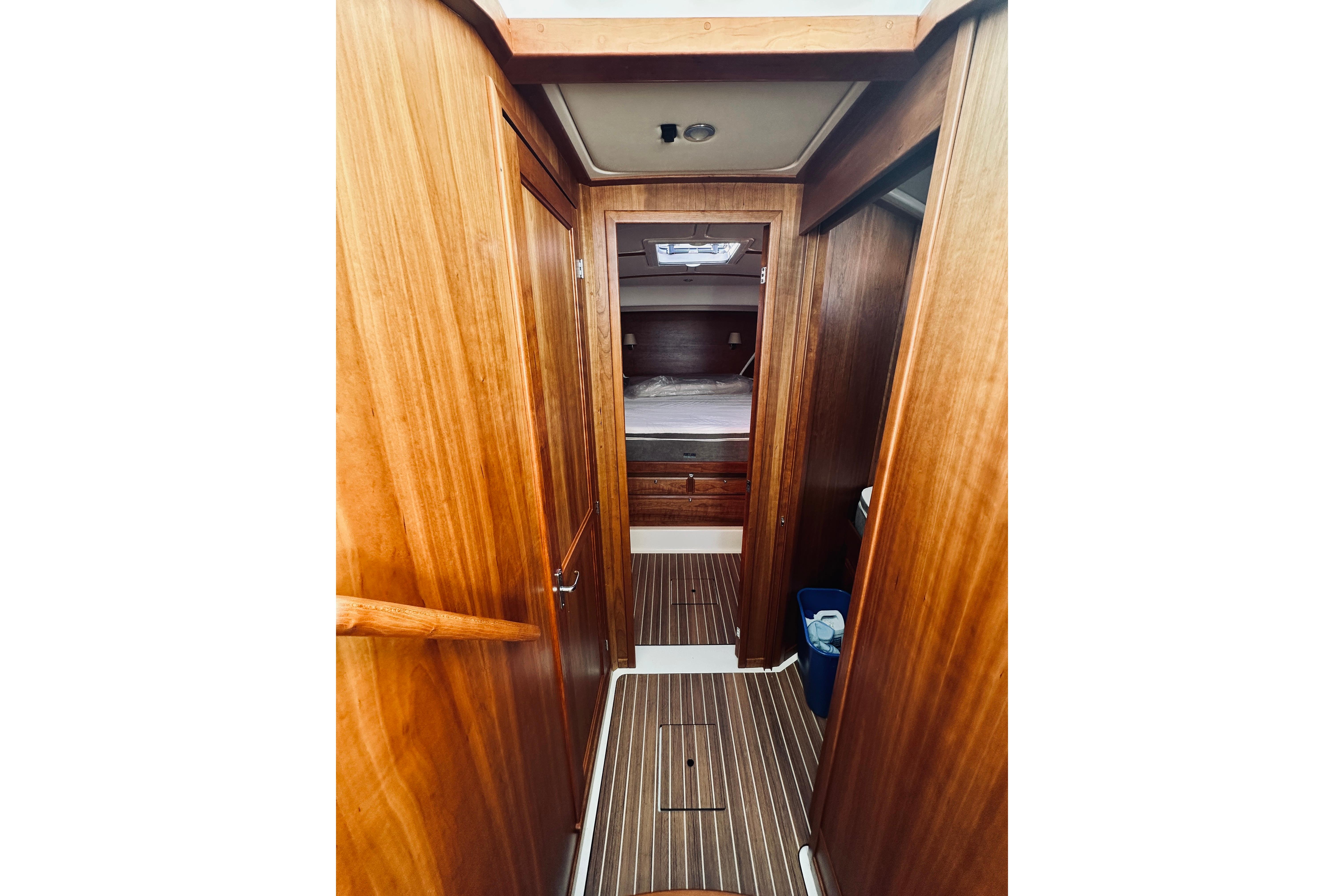 Interior of 2021 Back Cove 37 yacht, featuring wooden paneling and cozy cabin space.