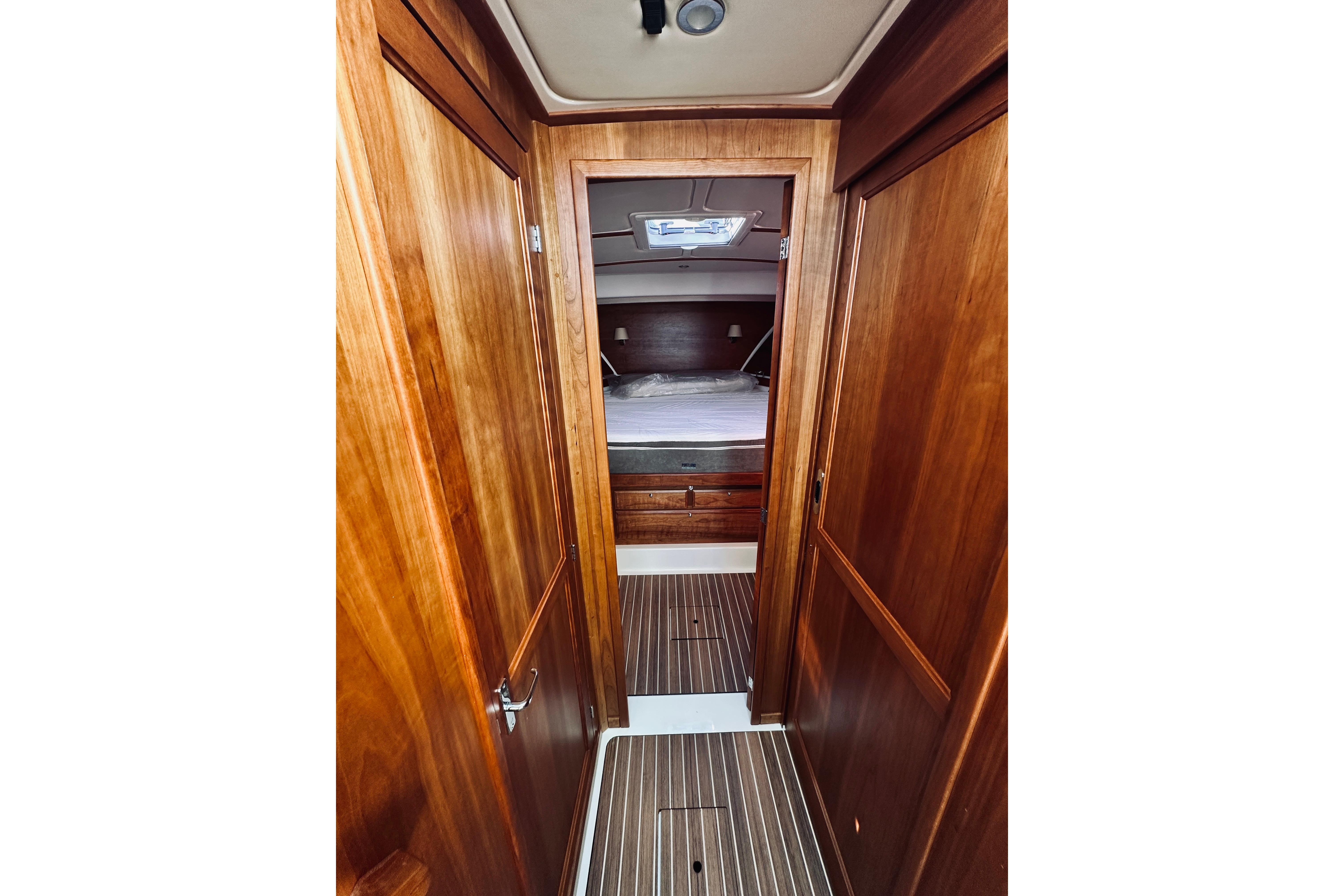 2021 Back Cove 37 interior cabin with wooden finish and cozy bed.