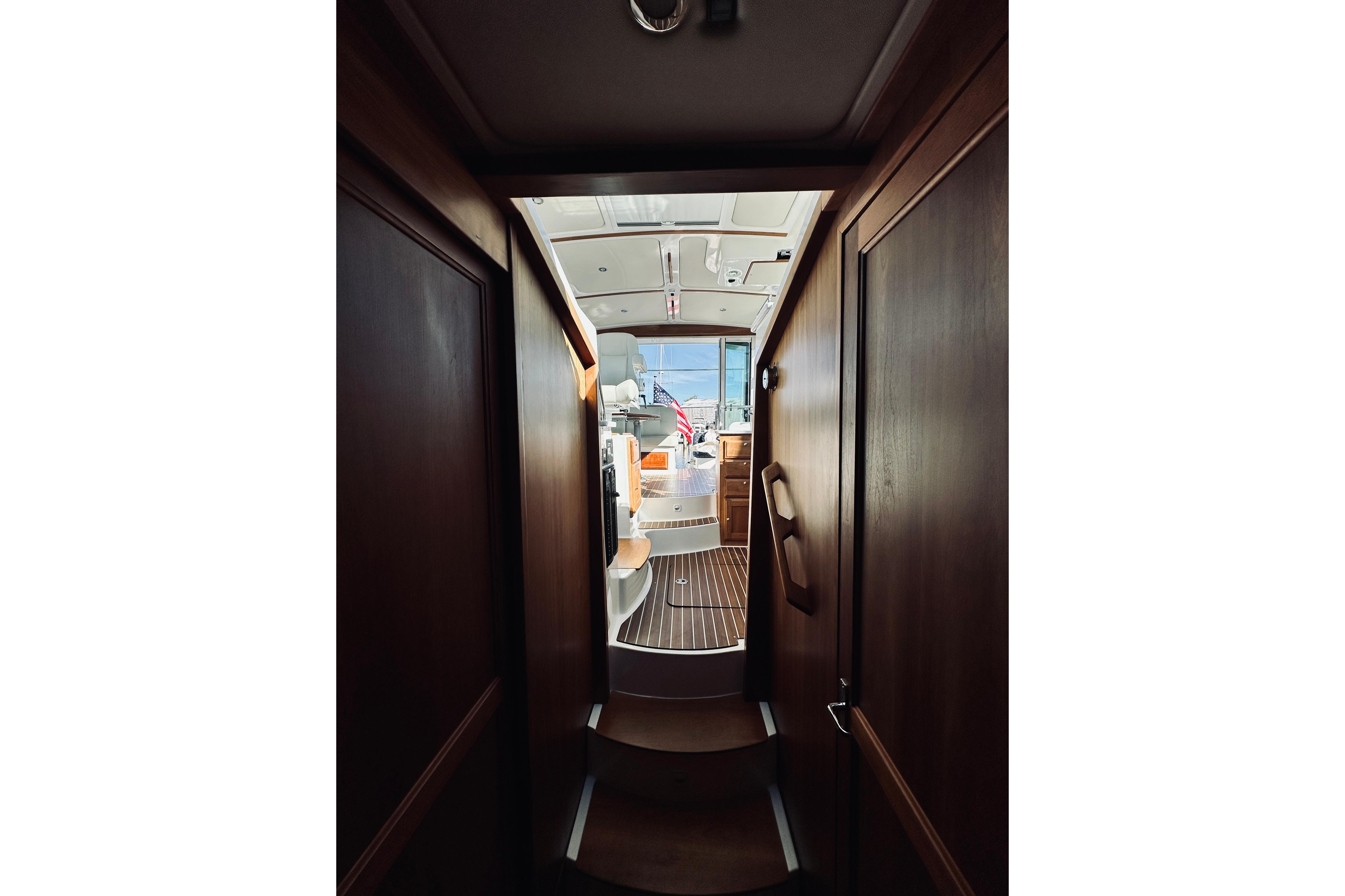 Interior view of 2021 Back Cove 37 yacht, showcasing elegant wood finishes and modern design.