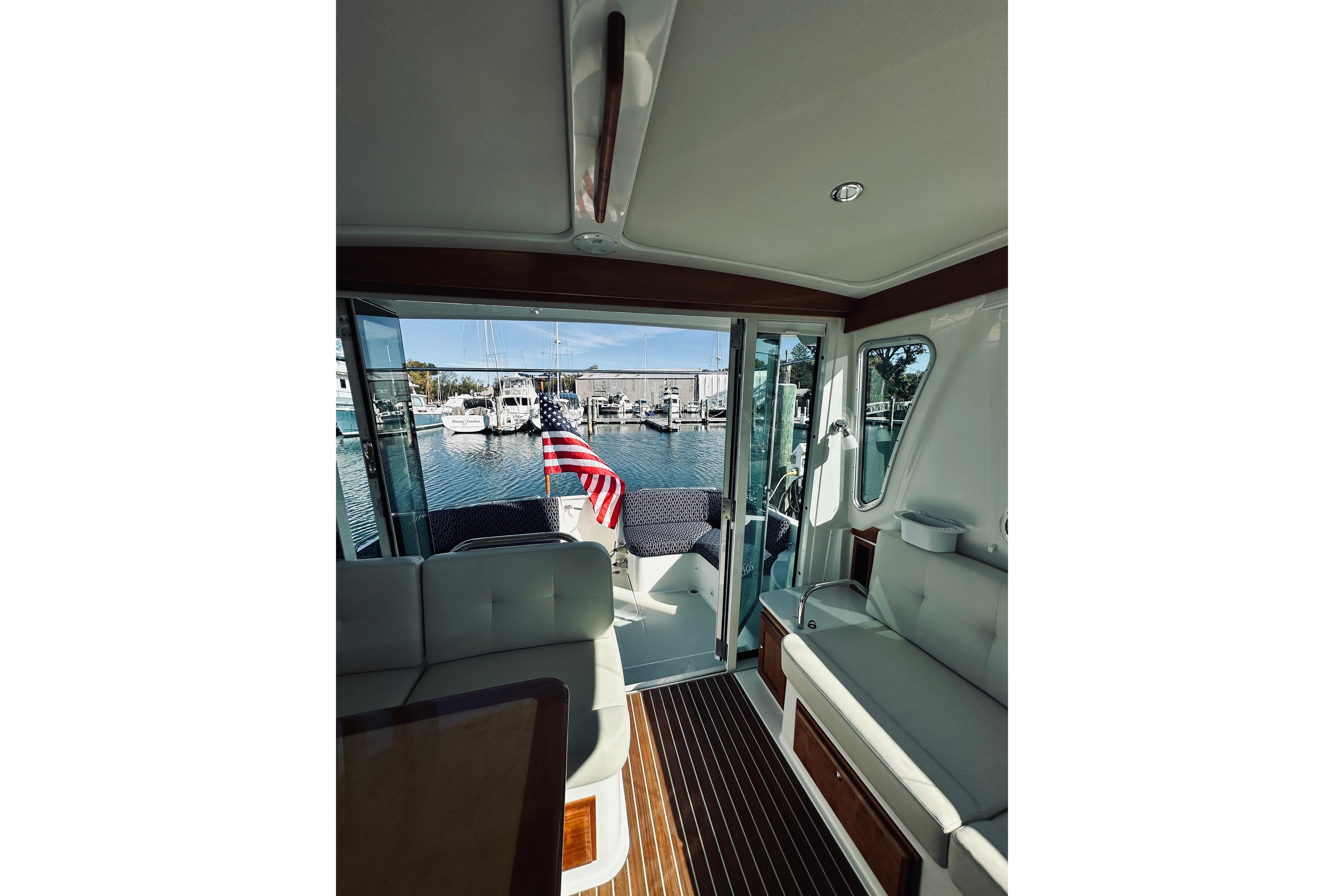Interior view of 2021 Back Cove 37 yacht with marina backdrop.