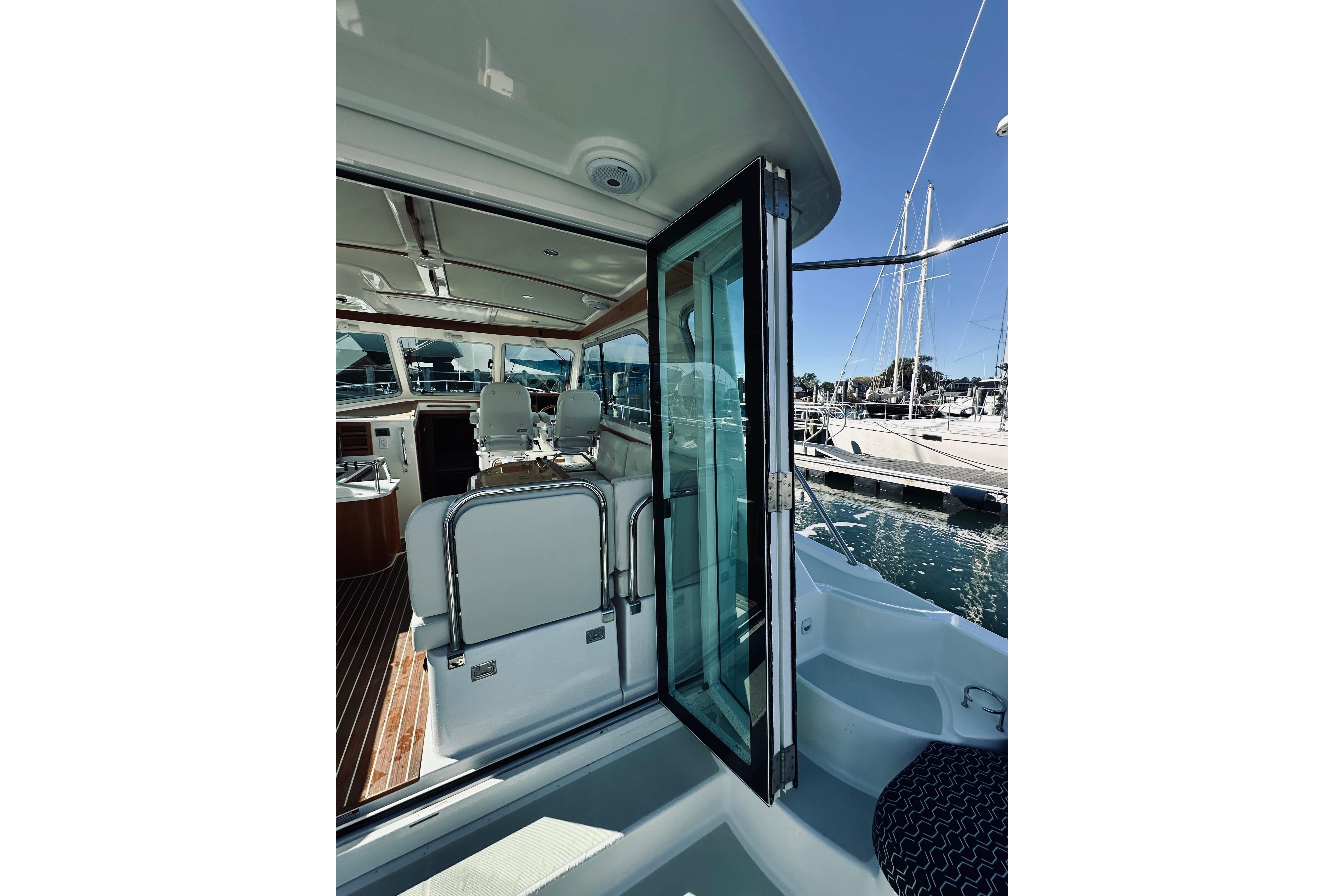 2021 Back Cove 37 yacht interior view with open door, docked at marina.
