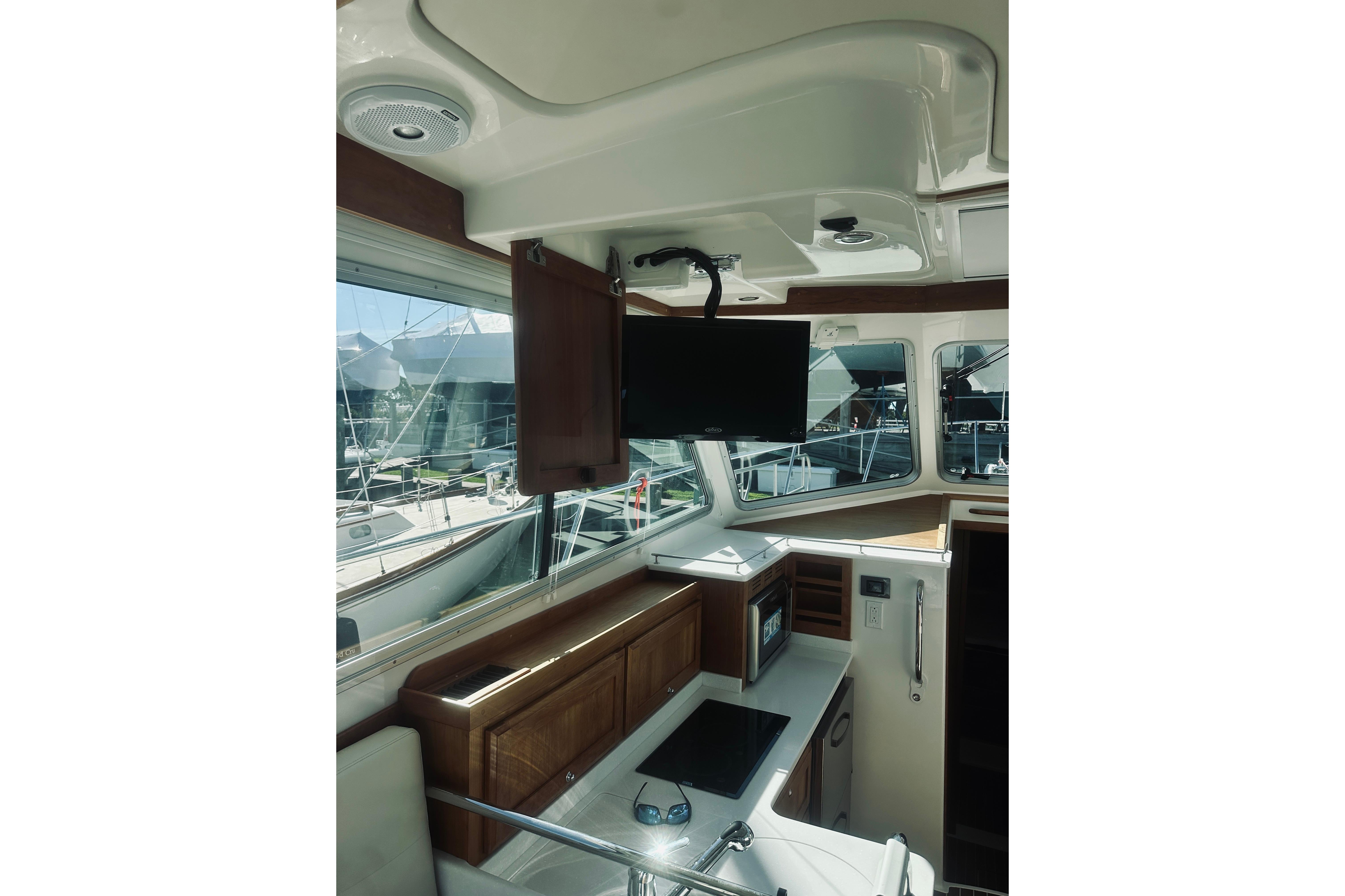 Interior of 2021 Back Cove 37 yacht with modern kitchen and mounted TV.