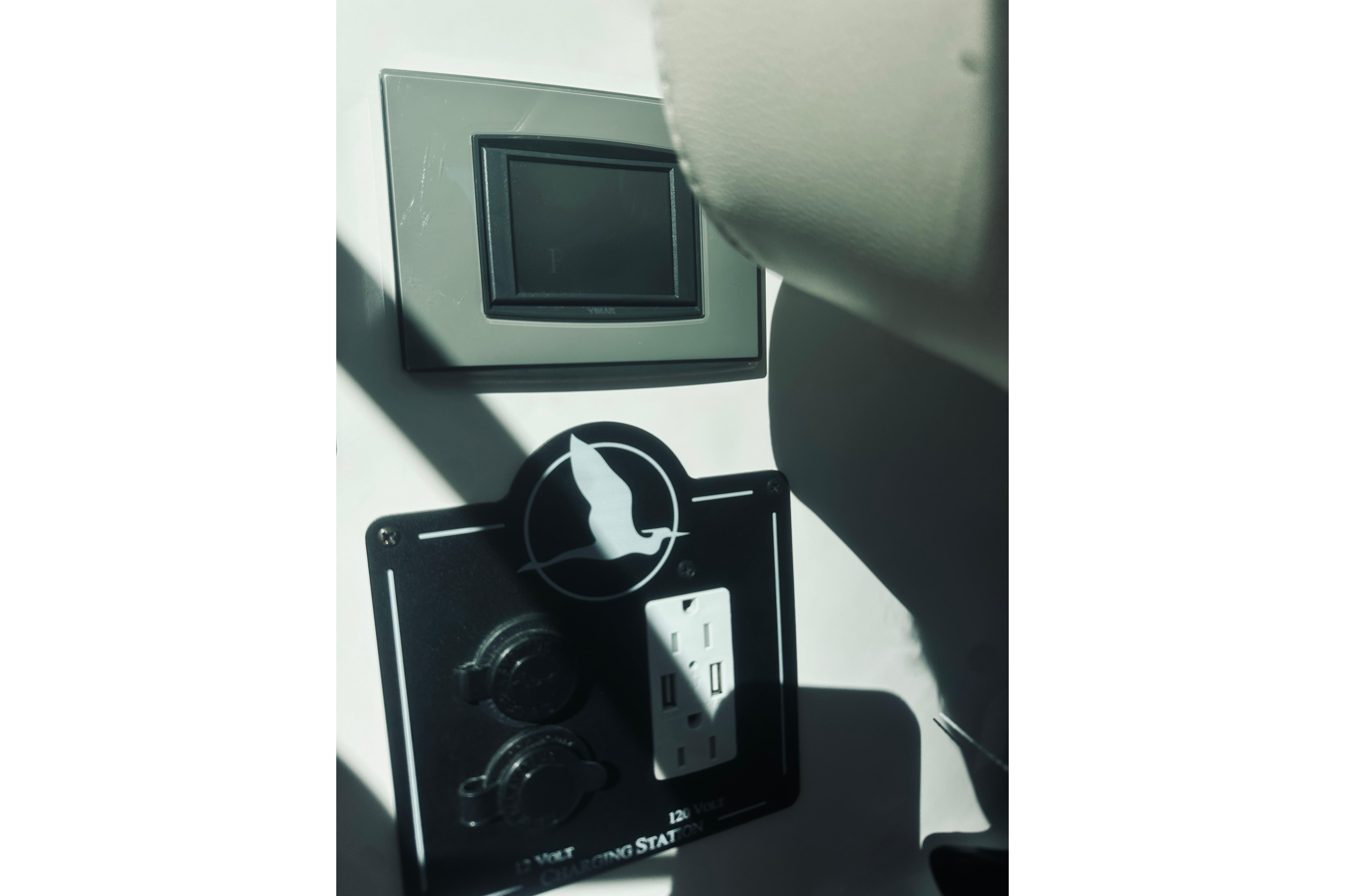 Control panel on a 2021 Back Cove 37 boat, featuring outlets and switches.