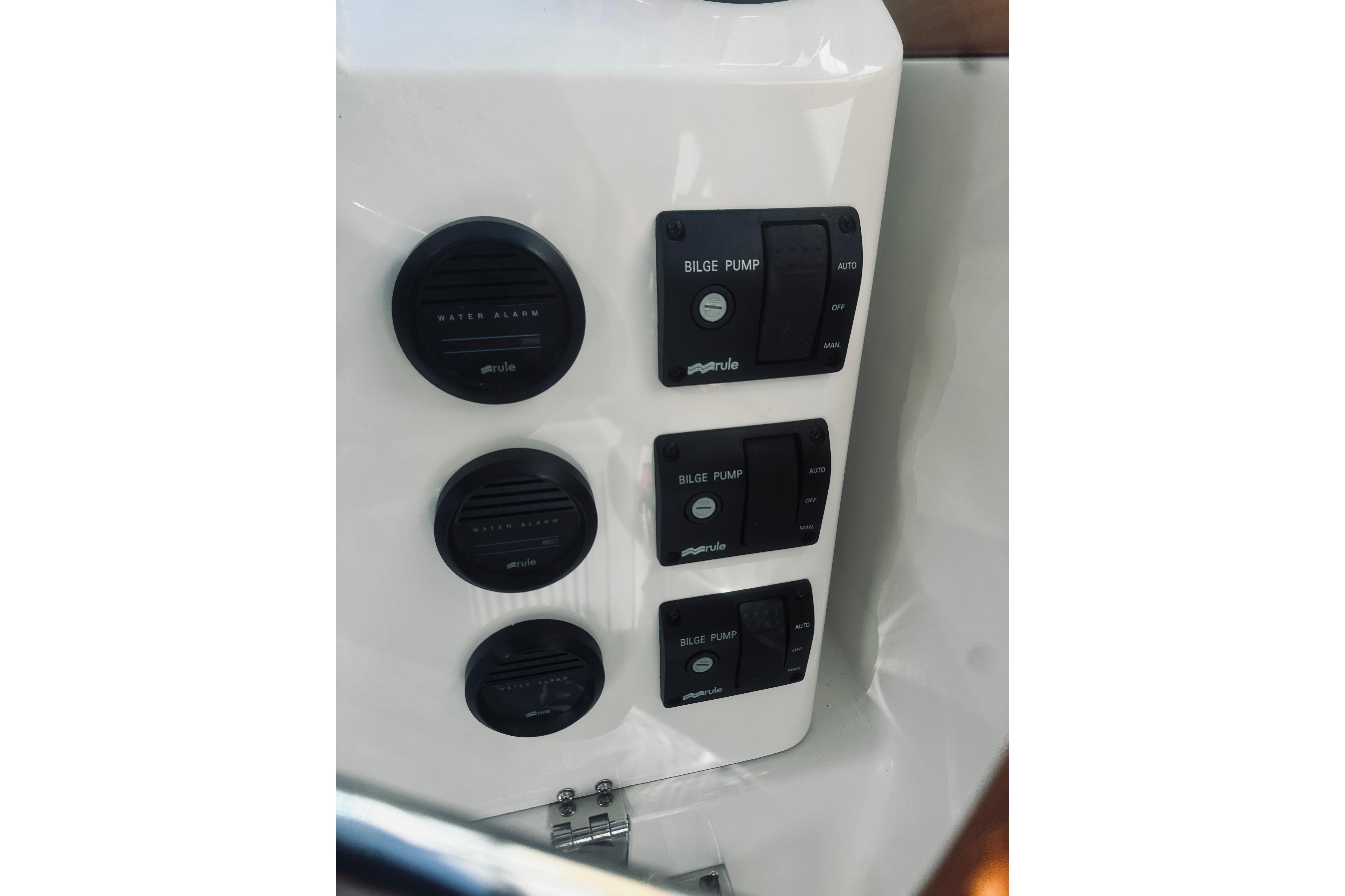Control panel of 2021 Back Cove 37 boat with bilge pump switches and water alarms.
