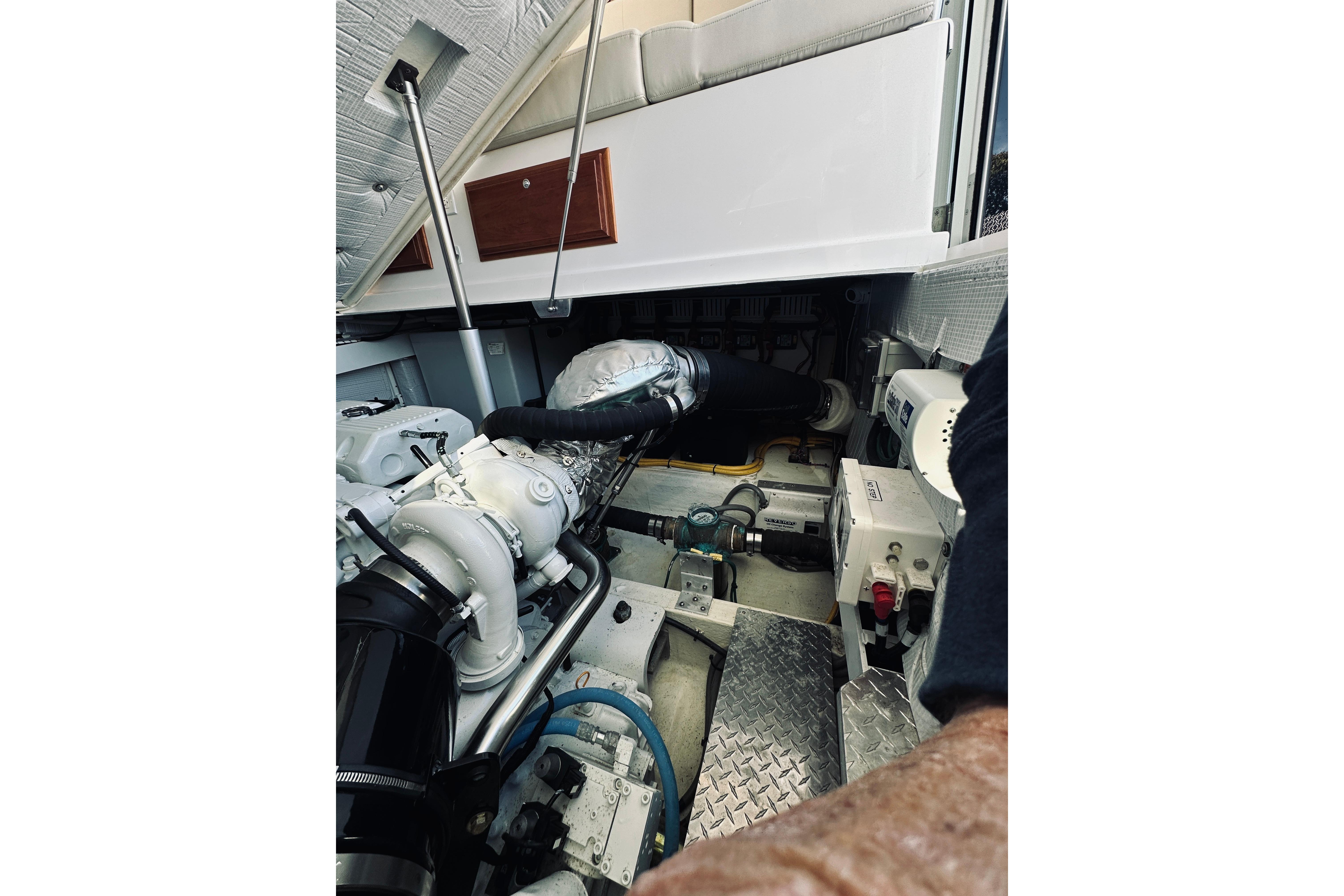 Engine compartment of a 2021 Back Cove 37 boat, showcasing mechanical components.