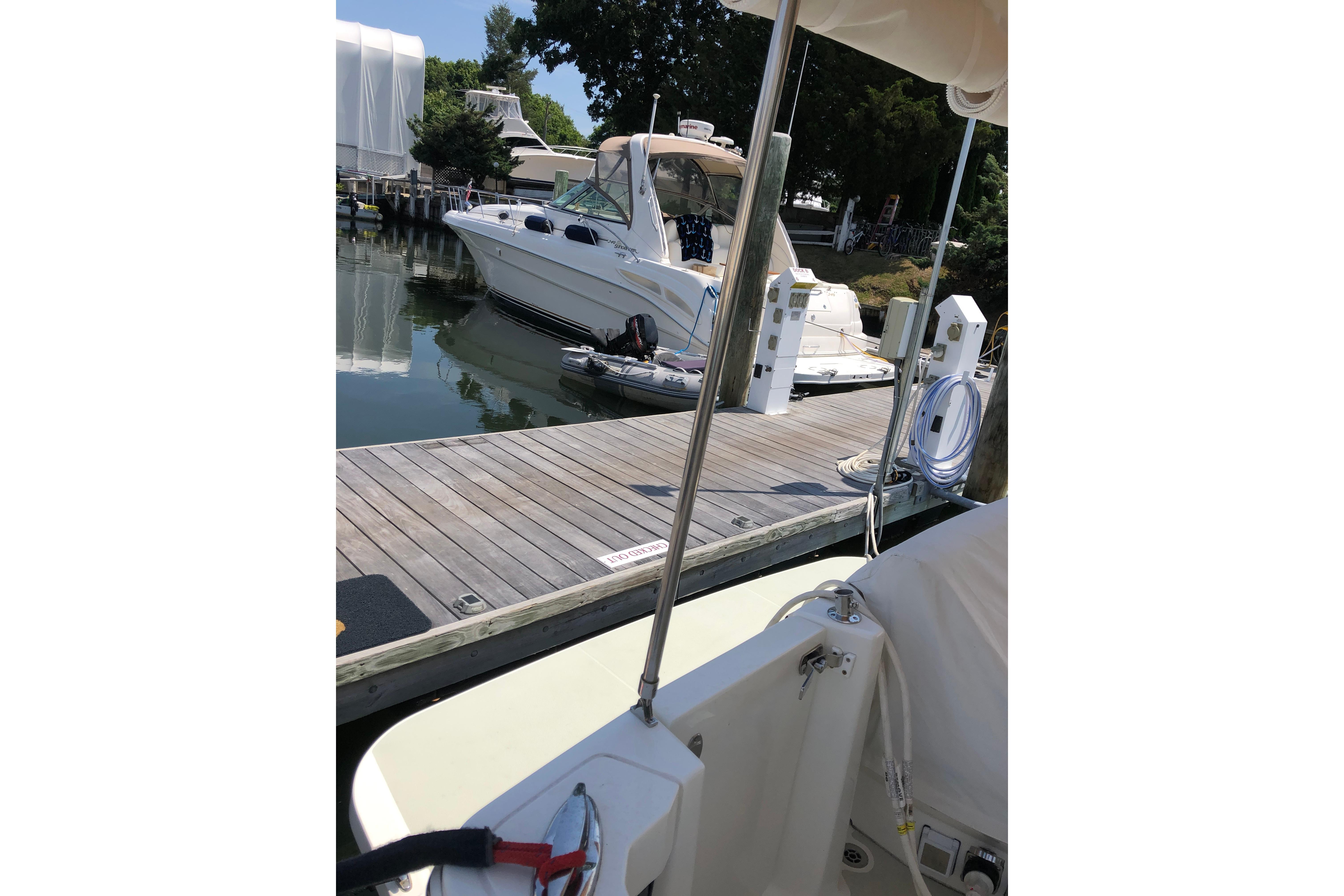 2021 Back Cove 37 docked at marina with nearby boat and equipment.
