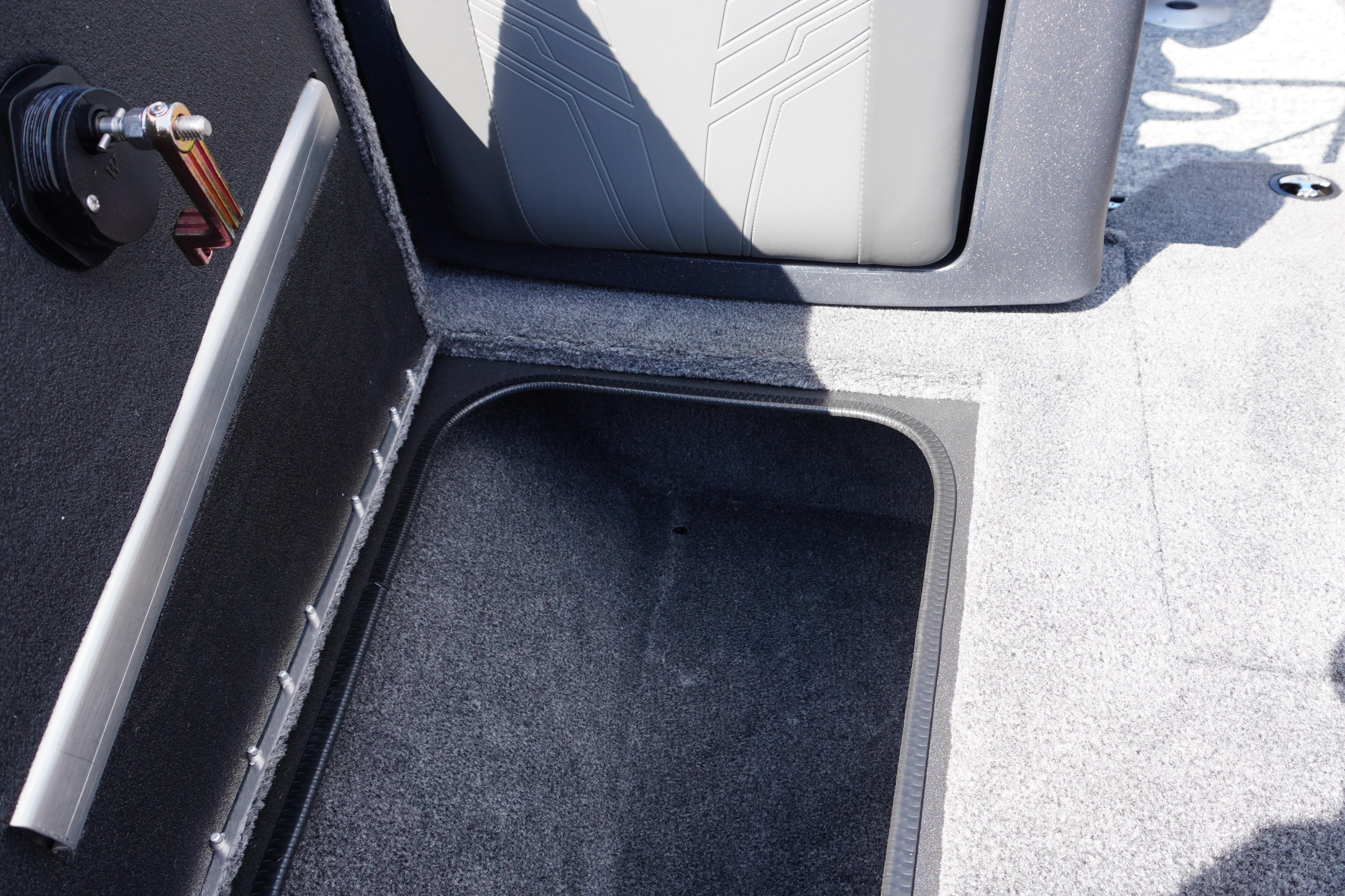 2026 Tracker Targa V-18 WT boat storage compartment with carpeted interior.