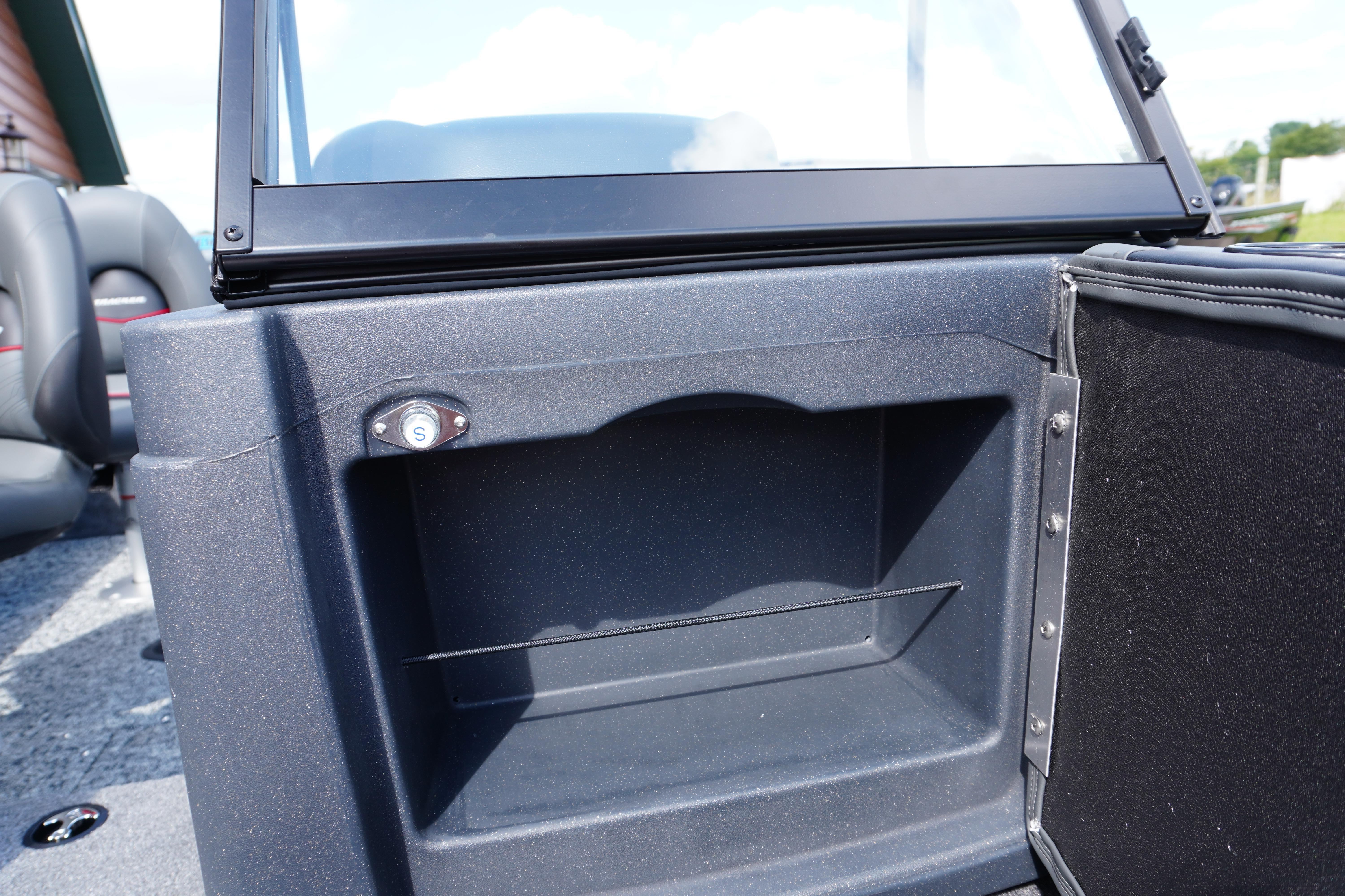 2026 Tracker Targa V-18 WT boat interior storage compartment with seating in background.