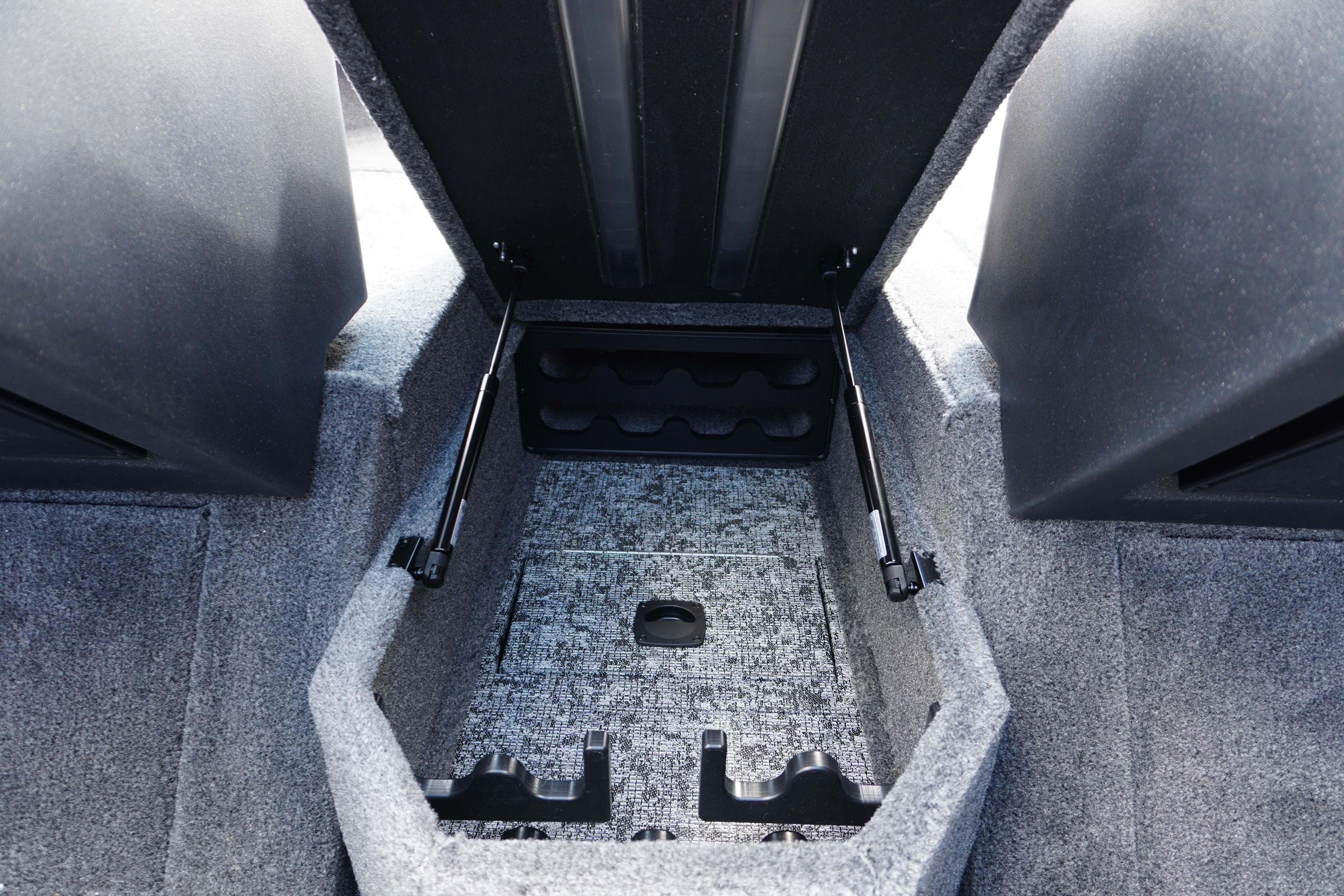 2026 Tracker Targa V-18 WT interior storage compartment with carpeted finish and hydraulic supports.