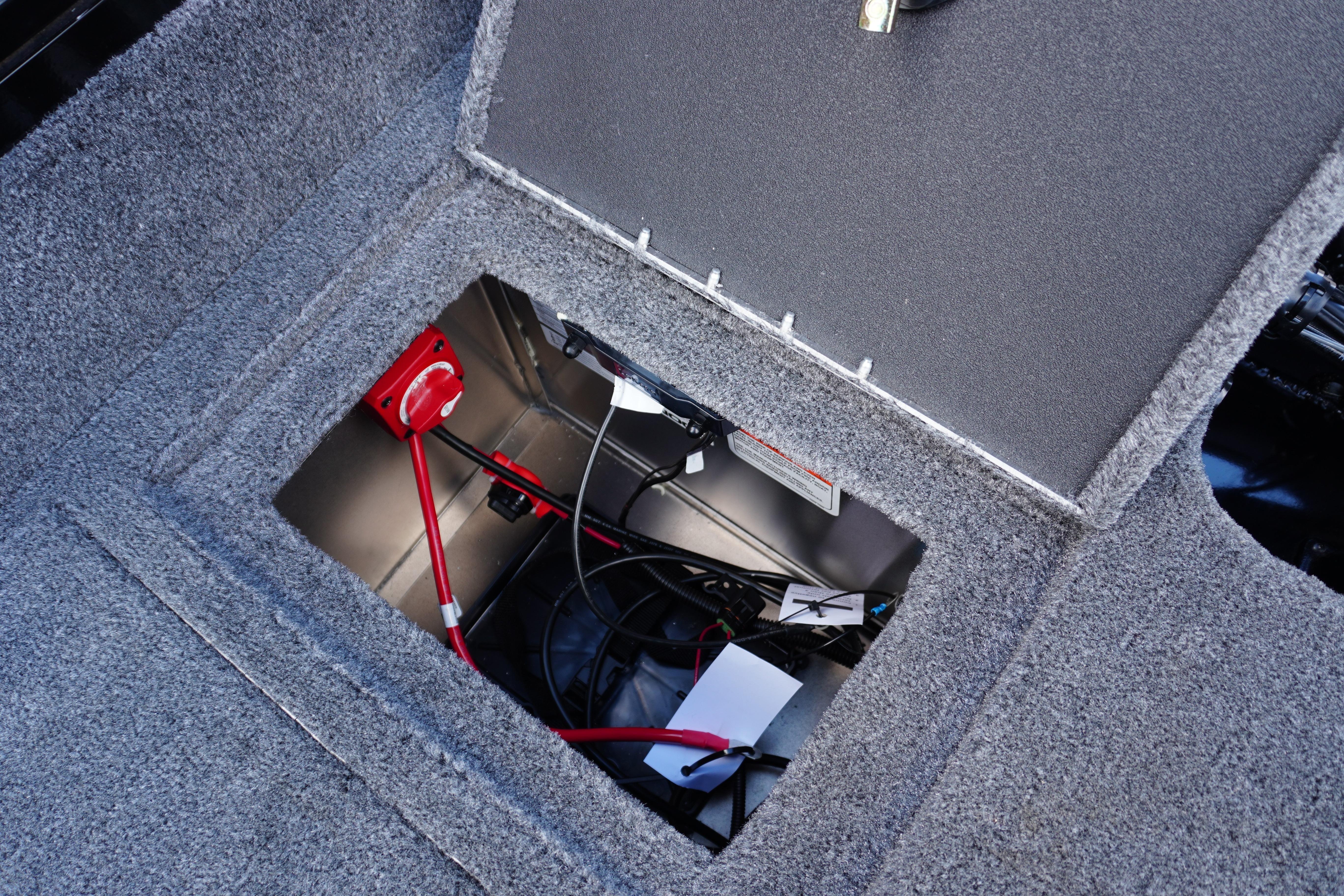 2026 Tracker Targa V-18 WT boat storage compartment with wiring and red switch.