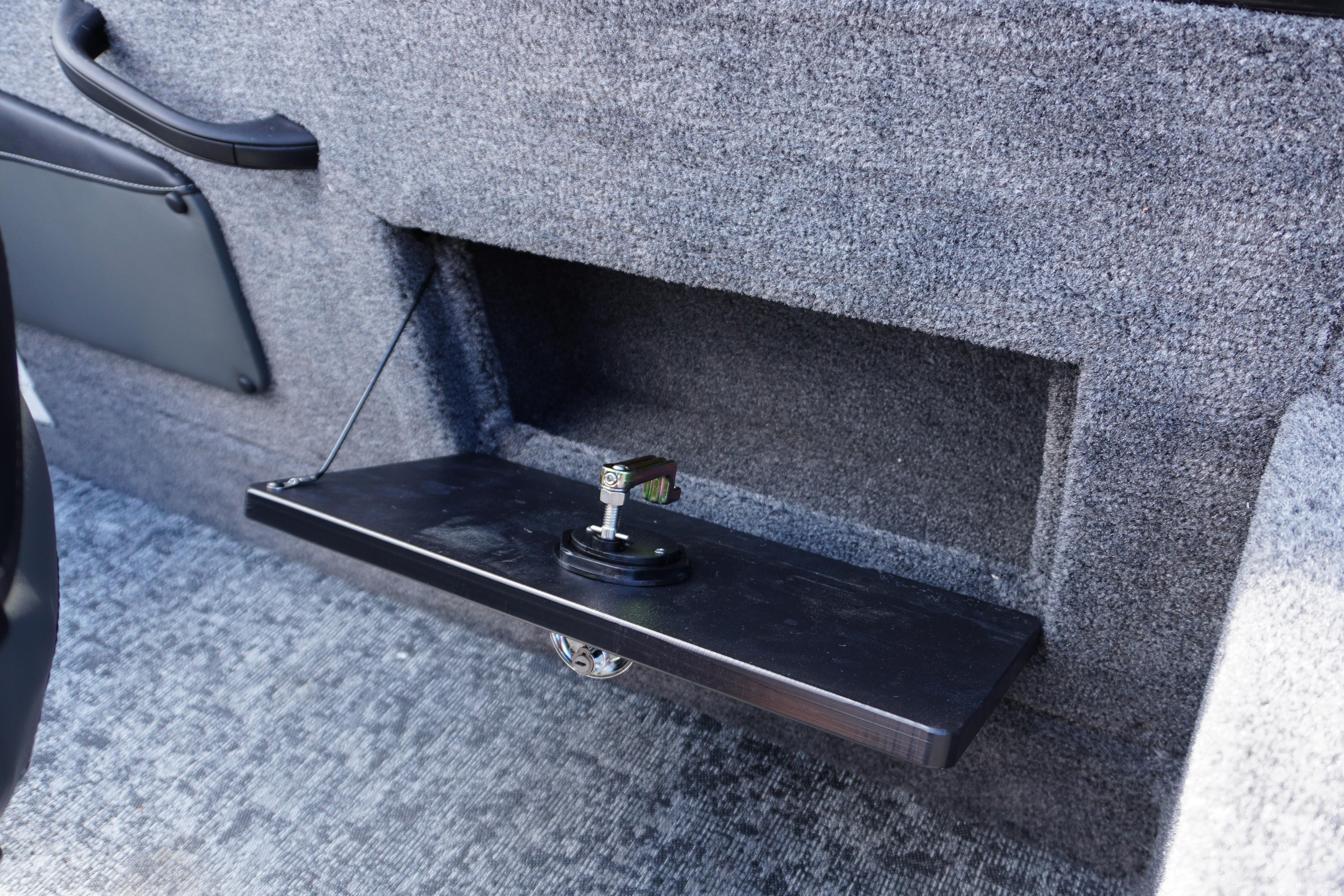 2026 Tracker Targa V-18 WT interior storage compartment with foldable shelf.