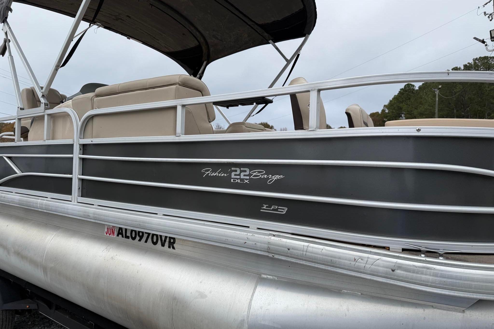 2019 Sun Tracker Fishin' Barge 22 XP3 pontoon boat with beige seating and gray exterior.