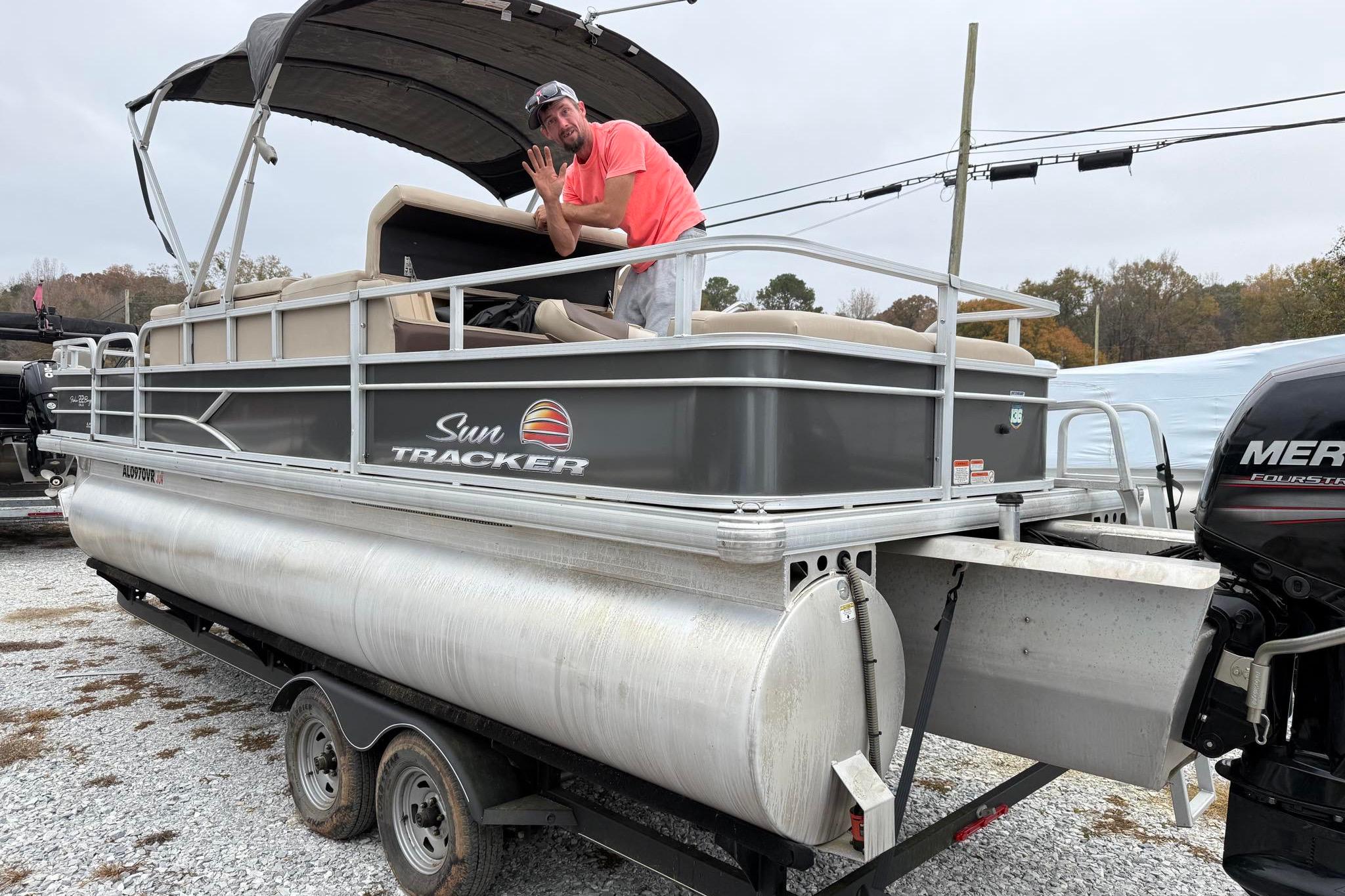 2019 Sun Tracker Fishin' Barge 22 XP3 pontoon boat on trailer with canopy and Mercury engine.