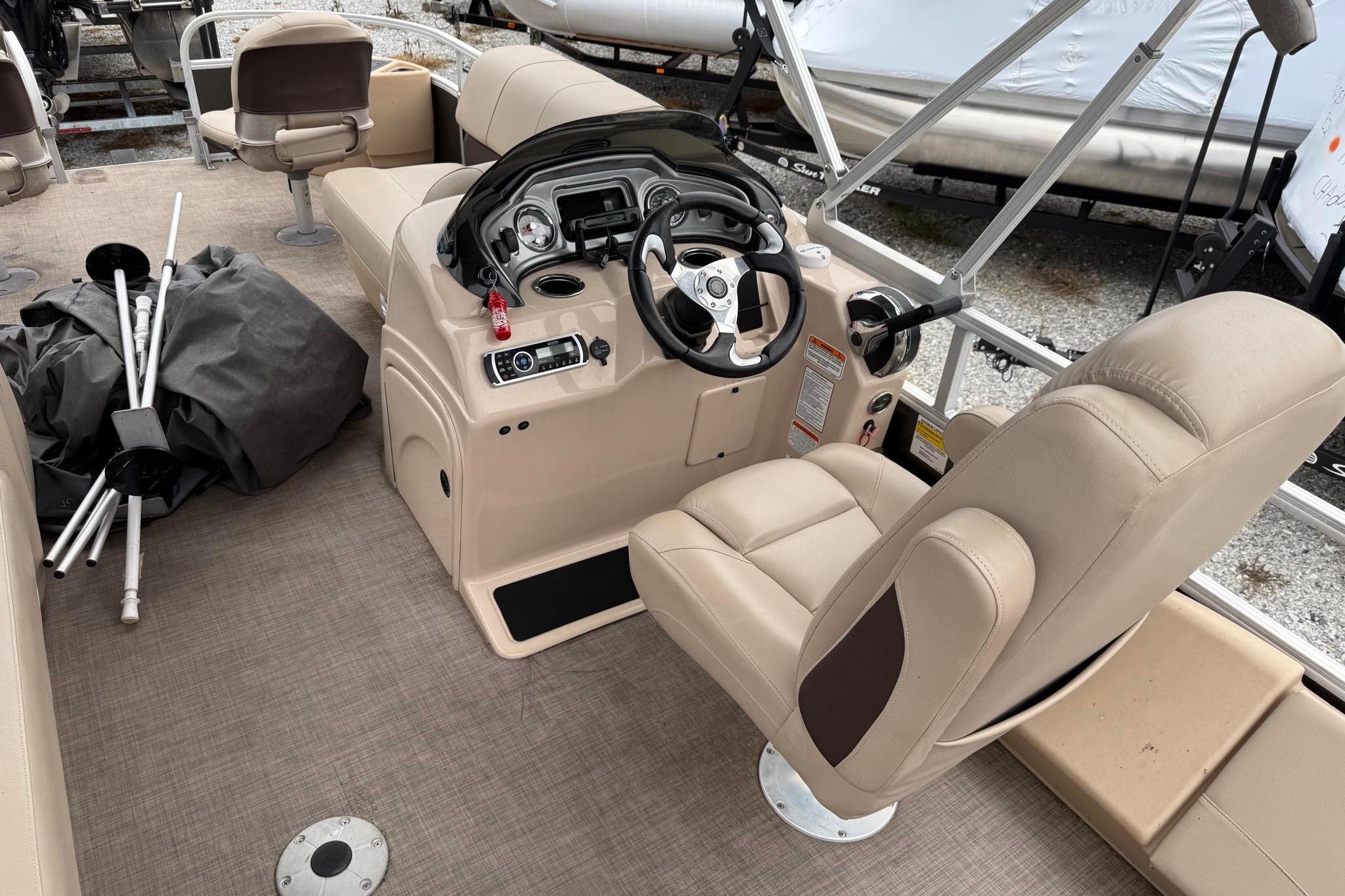 2019 Sun Tracker Fishin' Barge 22 XP3 interior with steering console and seating.