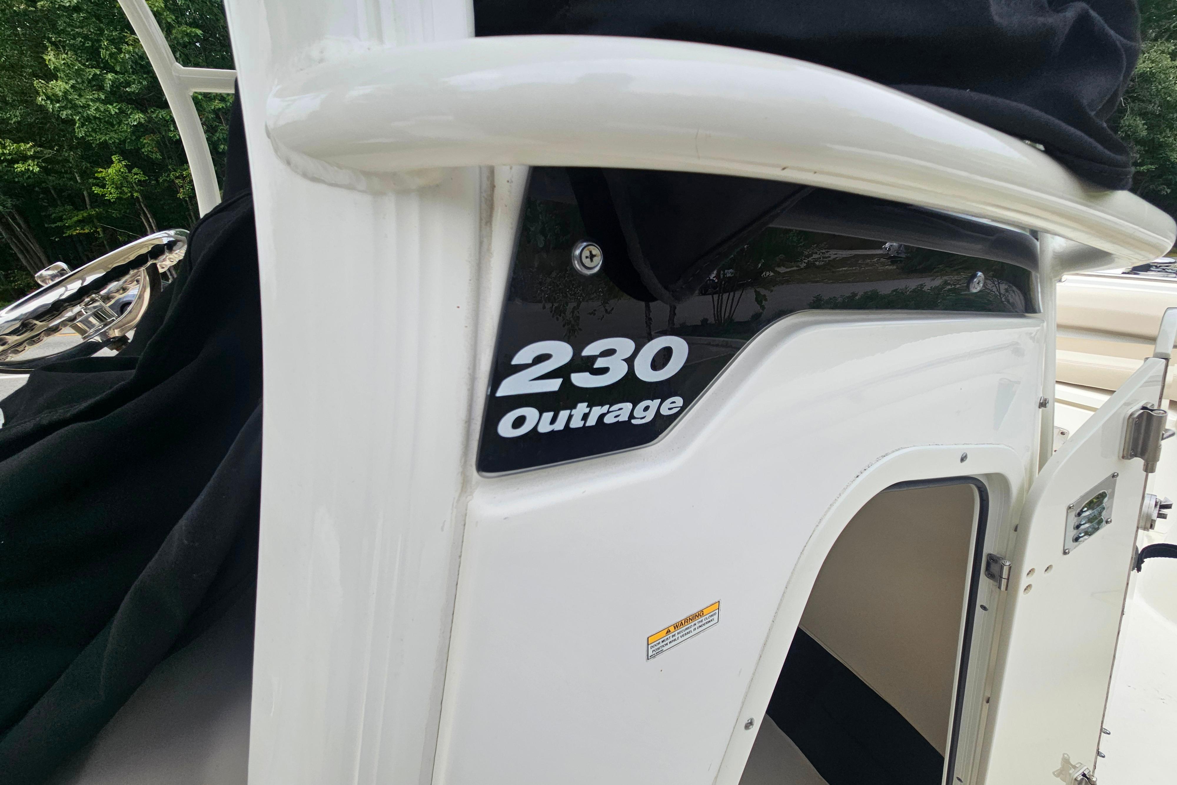 2019 Boston Whaler 230 Outrage boat, close-up of model name on side panel.