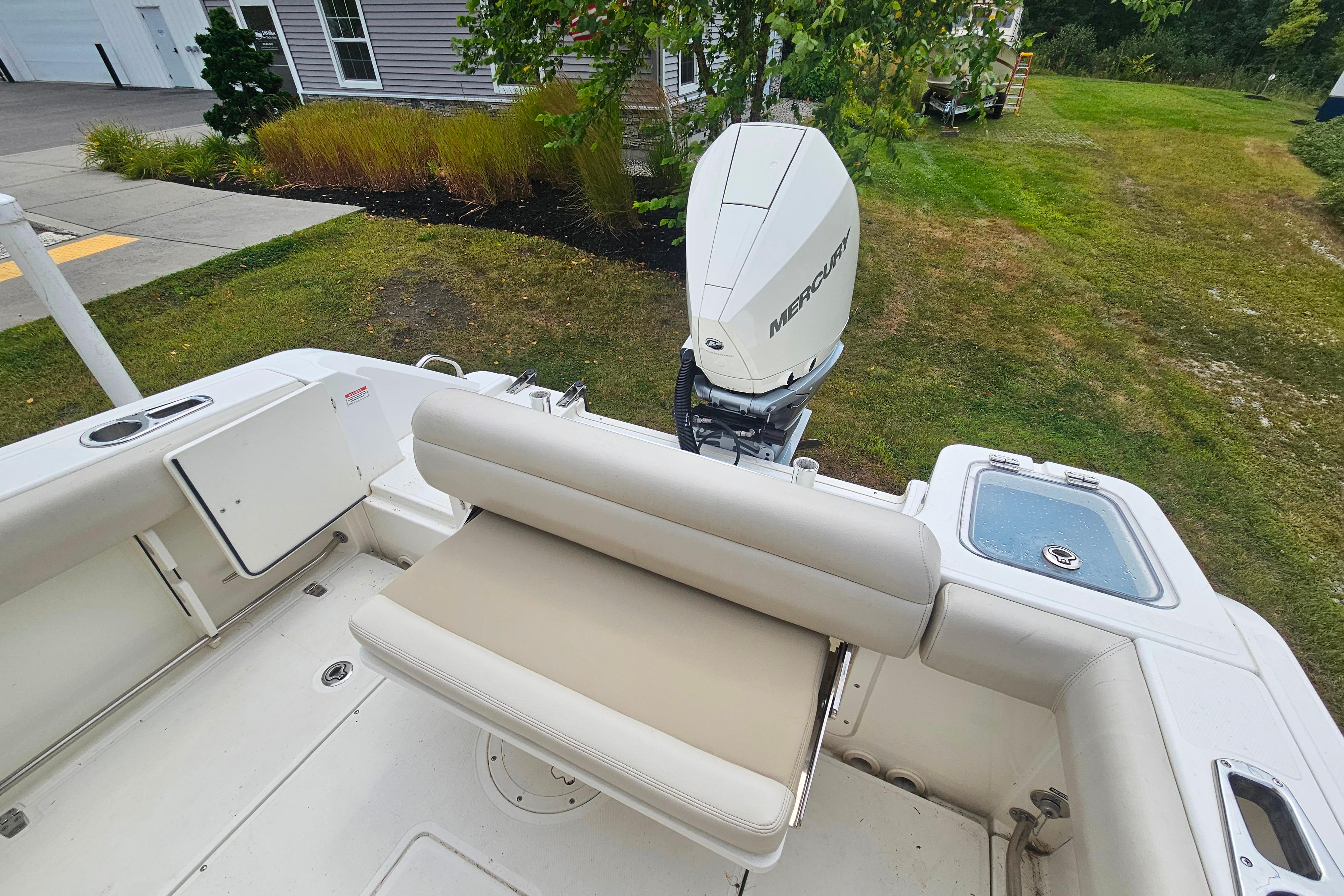 2019 Boston Whaler 230 Outrage boat with Mercury engine, featuring comfortable seating and spacious deck.