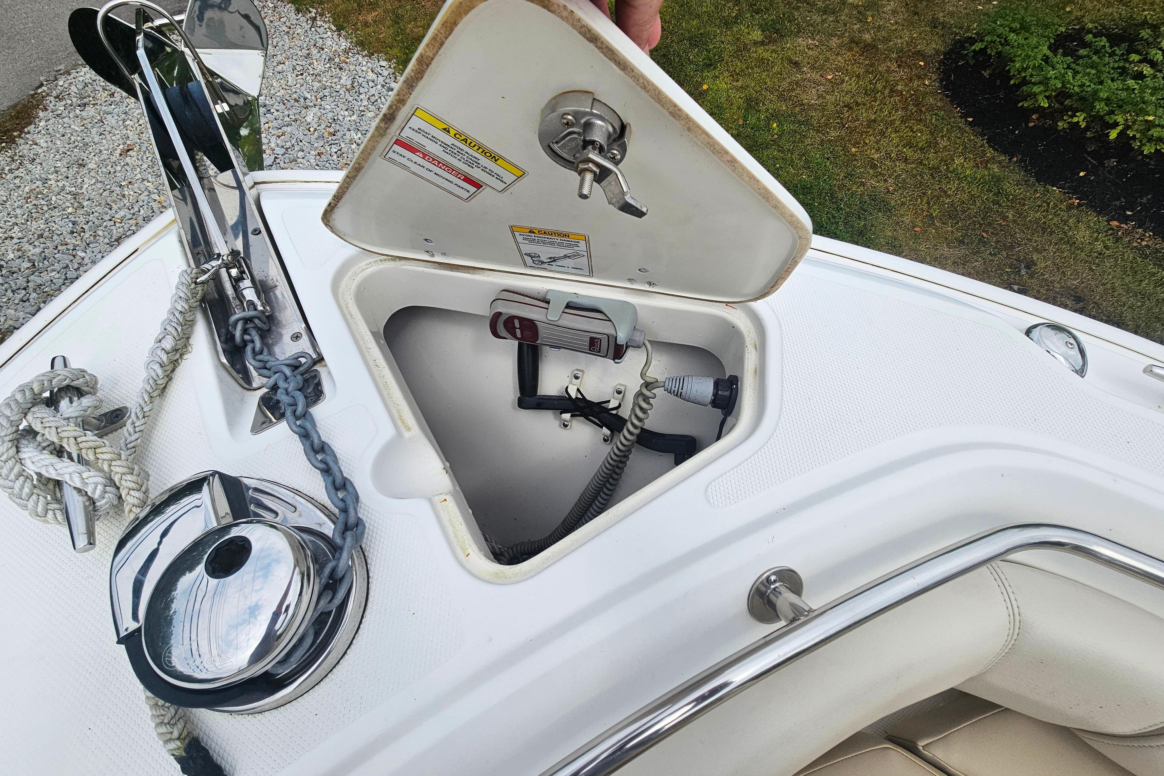 2019 Boston Whaler 230 Outrage anchor compartment with rope and winch.