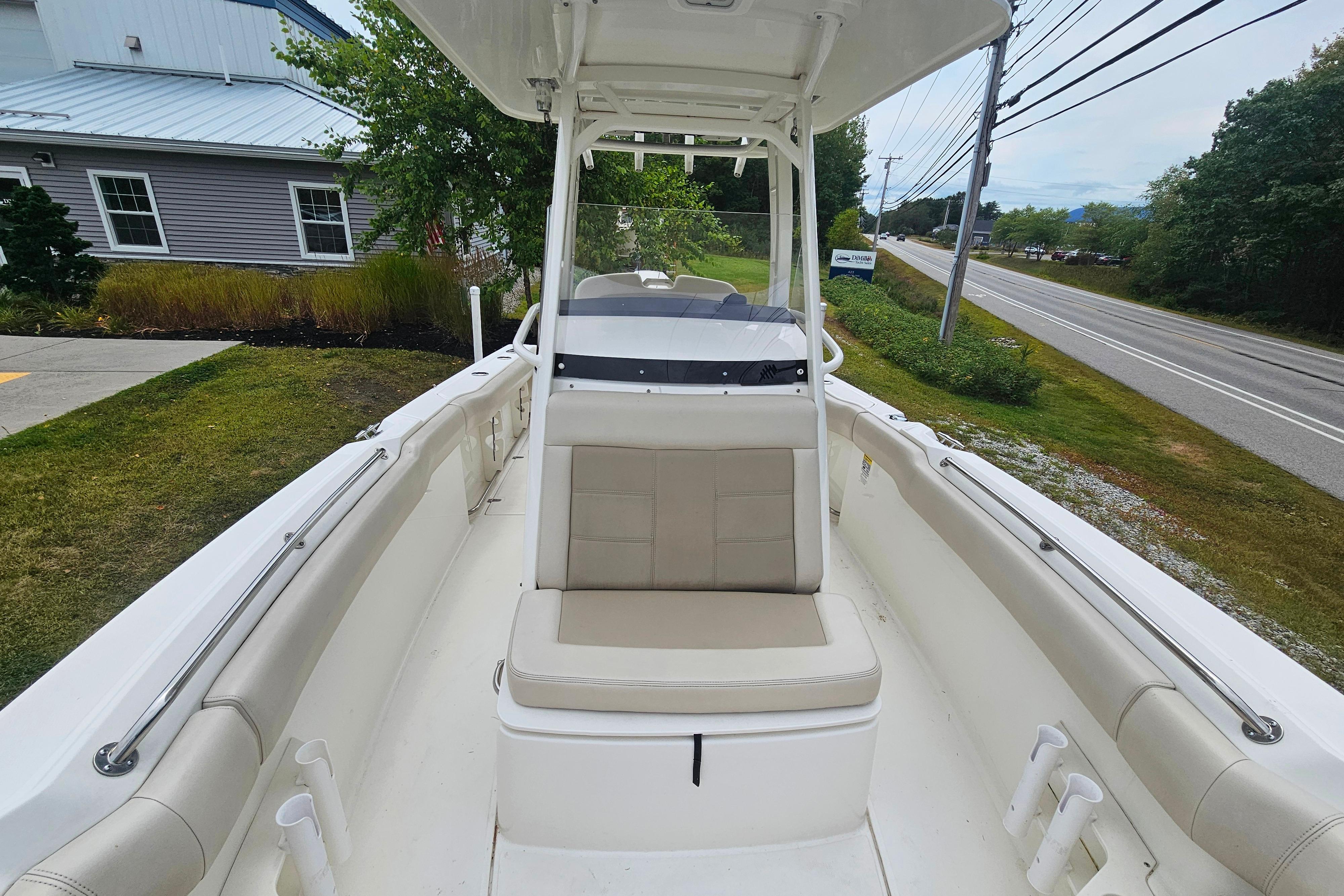 2019 Boston Whaler 230 Outrage boat interior with seating and console, parked near a road.