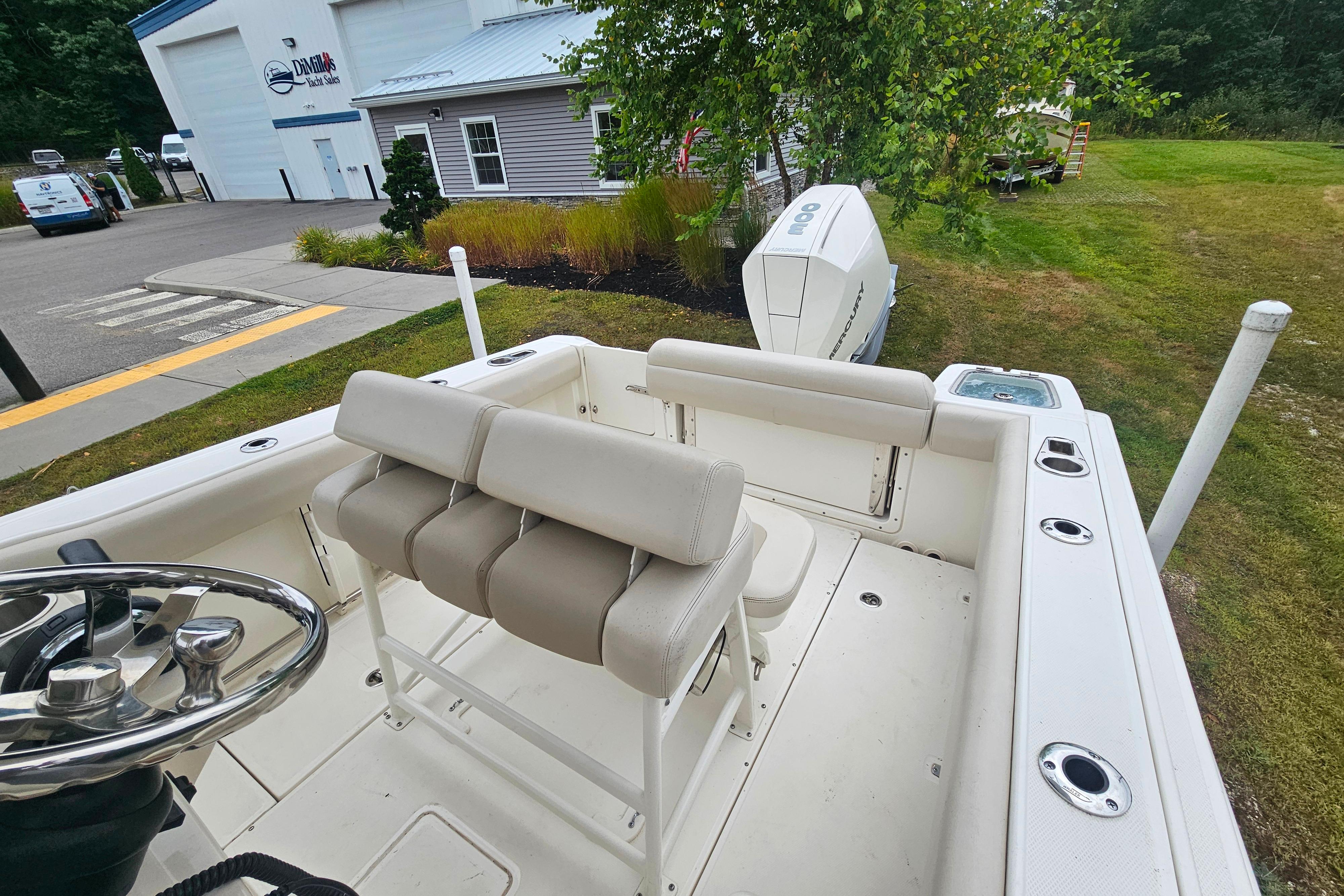 2019 Boston Whaler 230 Outrage boat interior with seating and steering wheel.